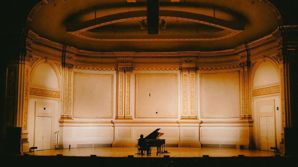 Cameron Winter performing solo at Carnegie Hall in Paul Thomas Anderson's 2026 concert documentary shot on 35mm film