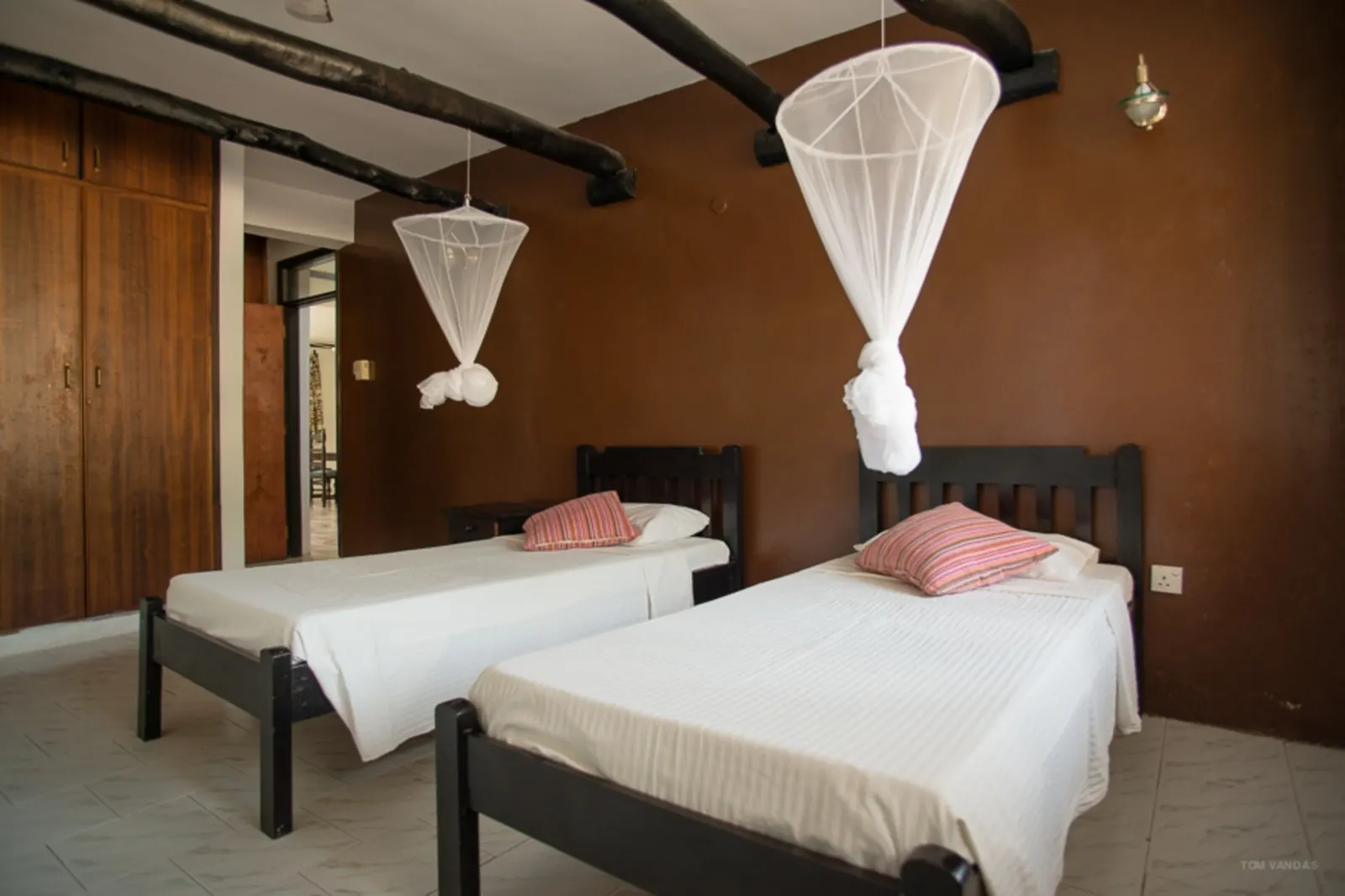 Twin guest room with mosquito nets at Bahari Dhow Beach Villas