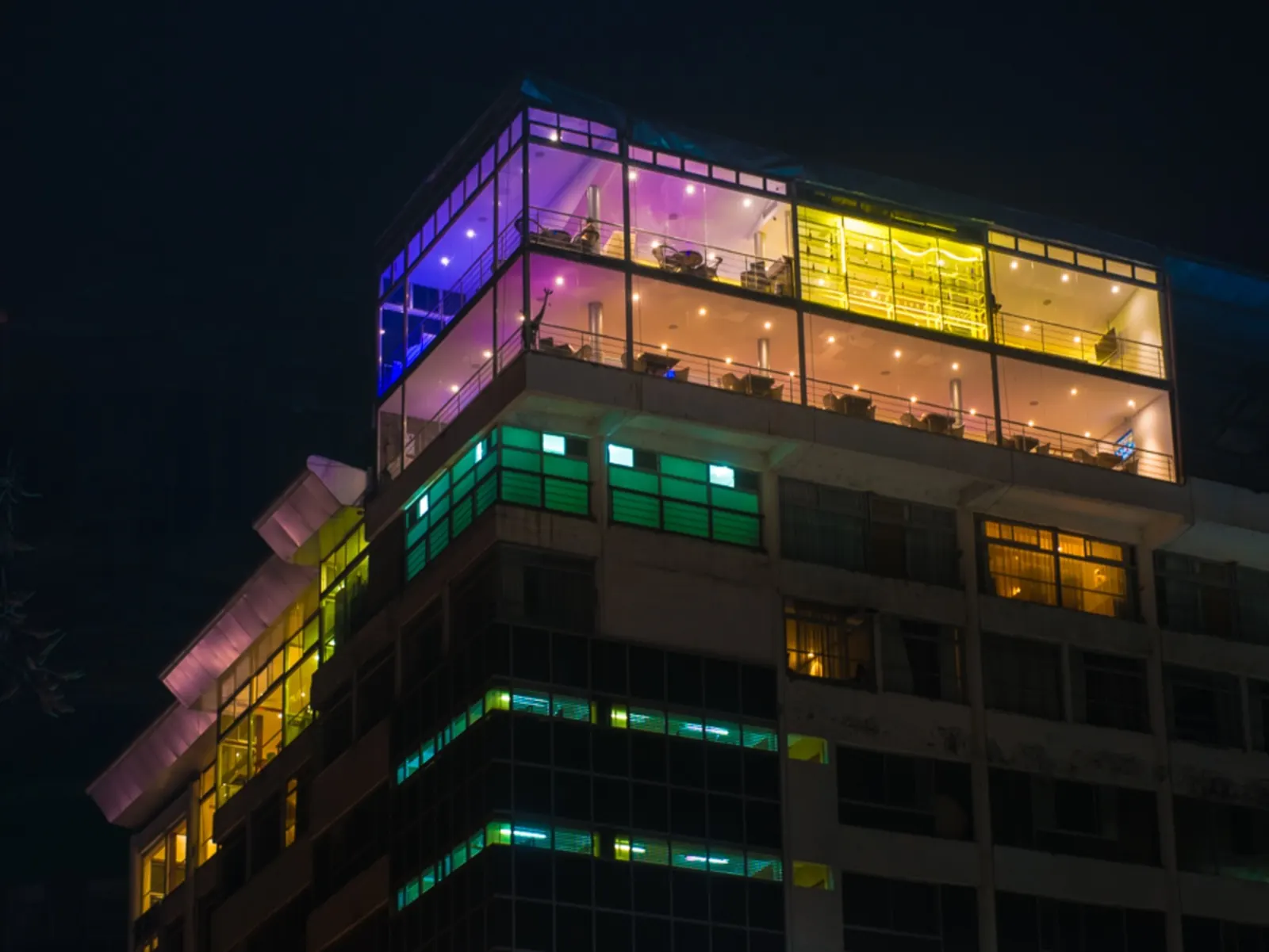 Cloud Hotel & Suites exterior illuminated at night