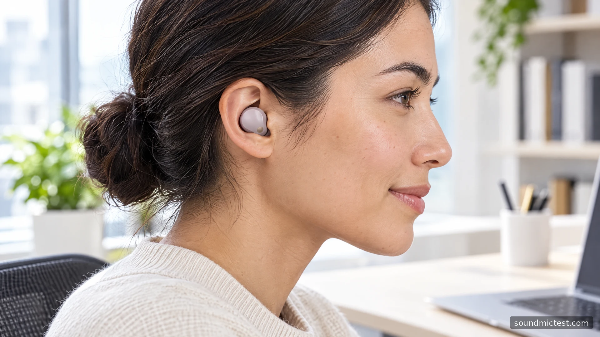 Sony WF-1000XM5 earbud worn at an office desk