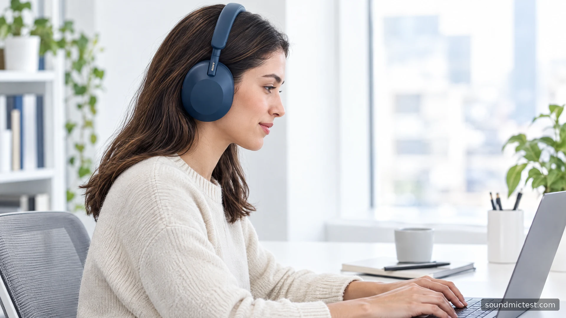 Side view of blue Sony WH-1000XM5 headphones worn at an office desk