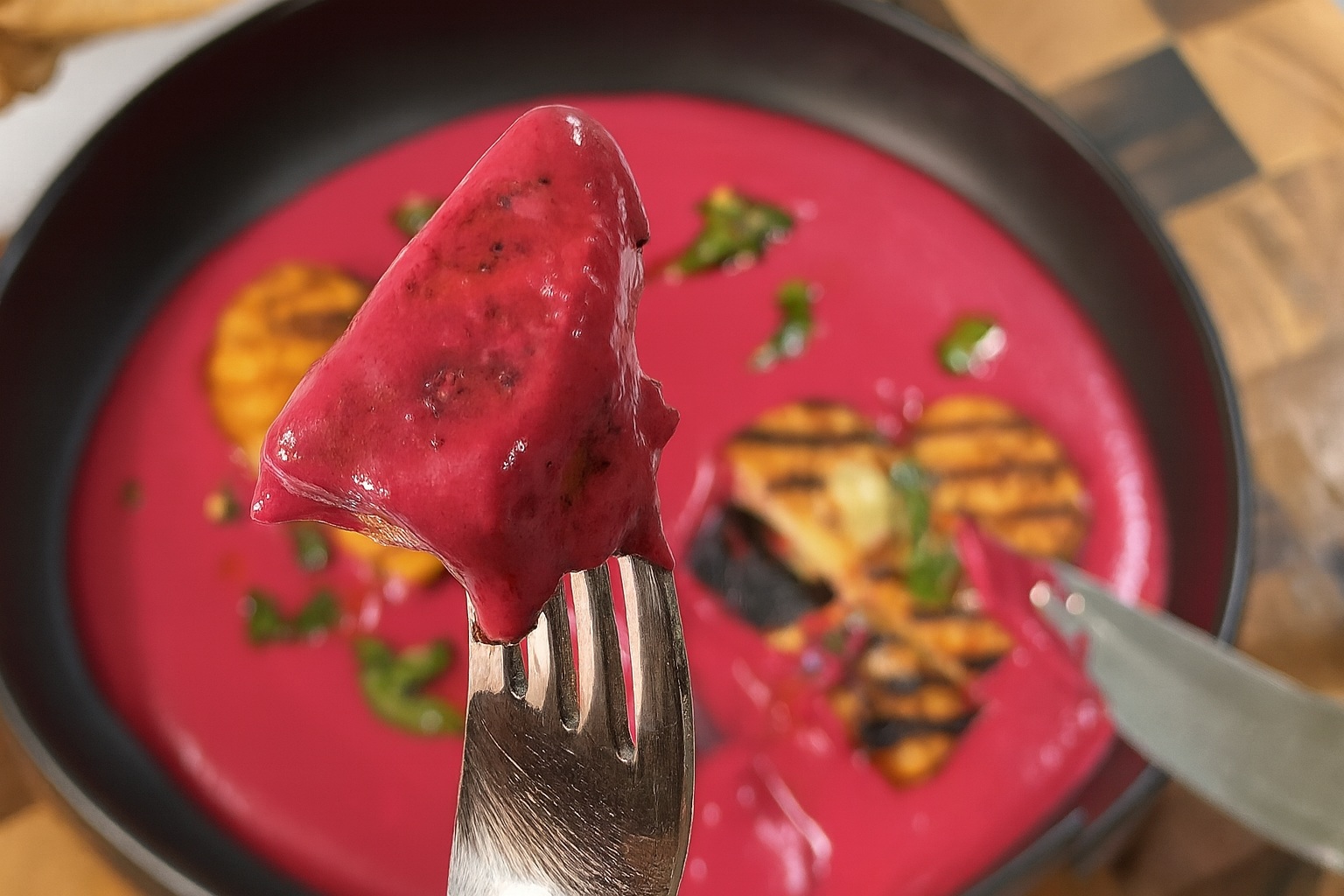 Grilled heart-shaped paneer on a vibrant pink beetroot yogurt sauce