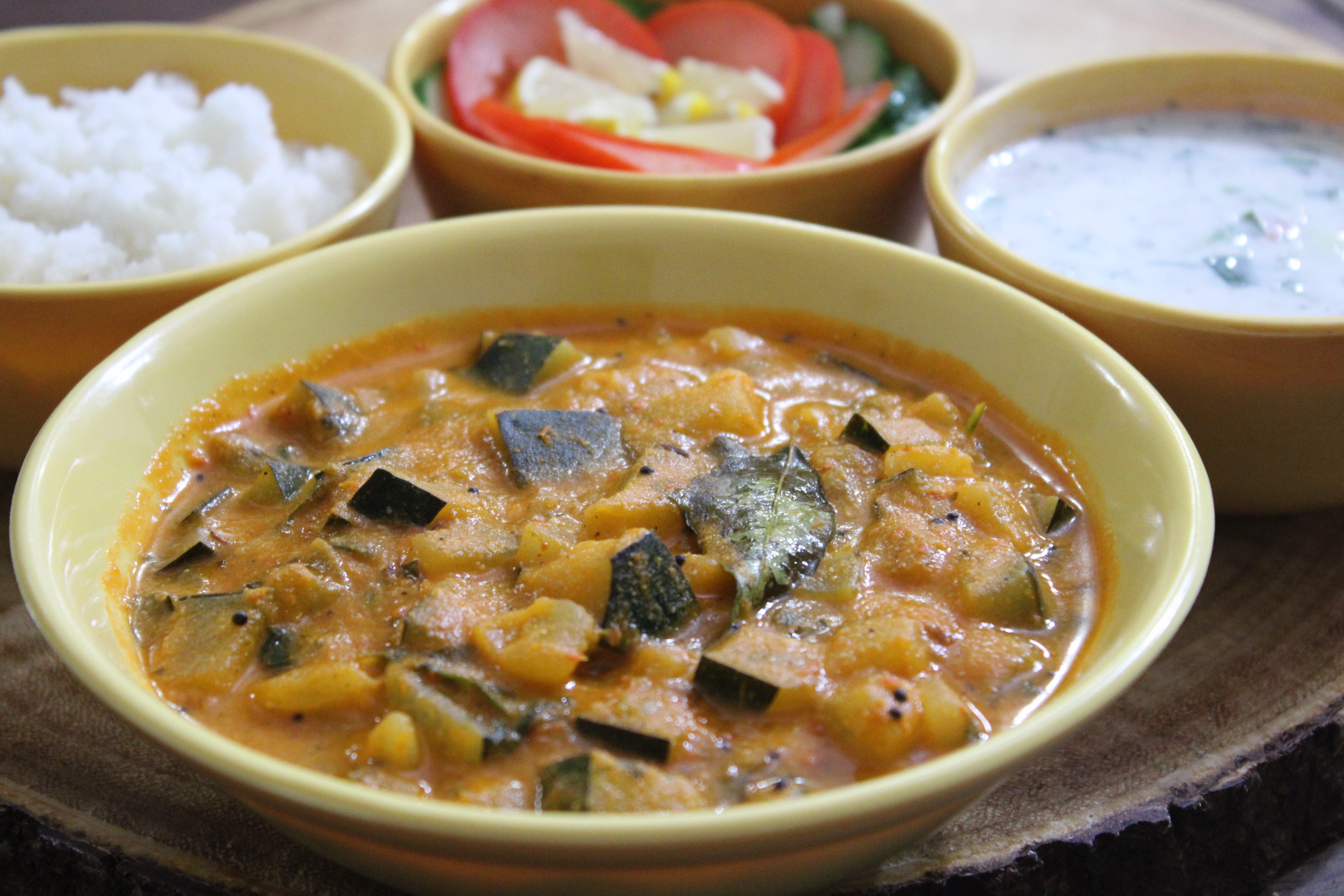 South Indian Zucchini Curry with black chana and white peas in a tangy base