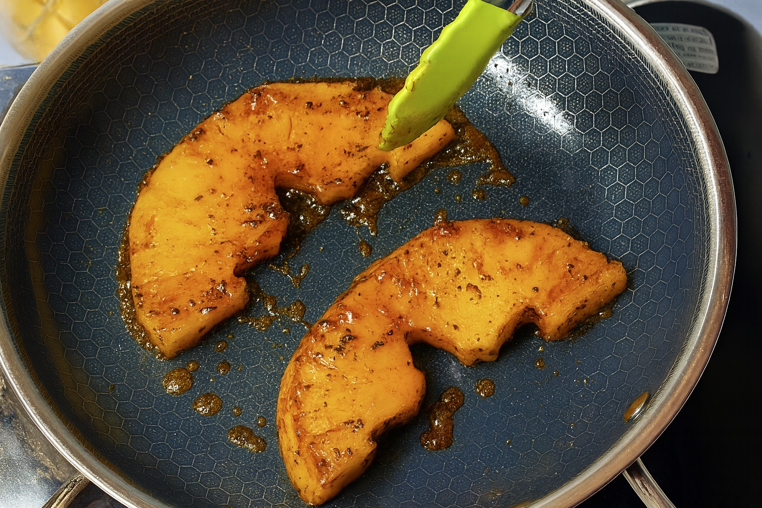 Charred spicy pineapple slices topped with tahini and honey