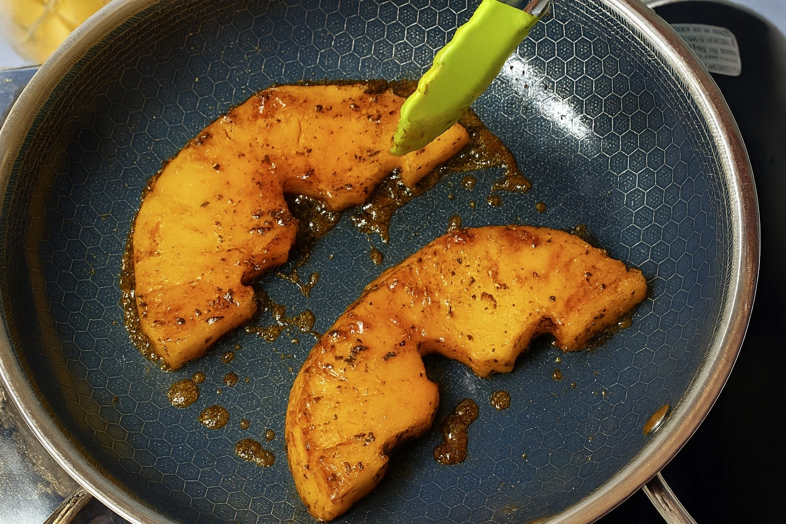 Charred spicy pineapple slices topped with tahini and honey