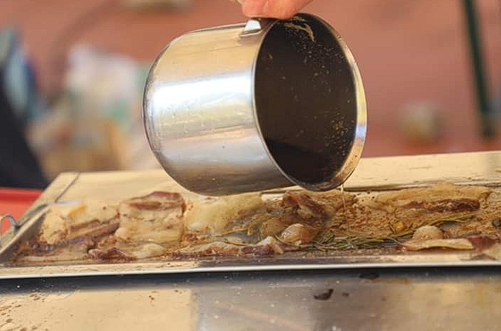 Golden sauce dripping from roasted meat