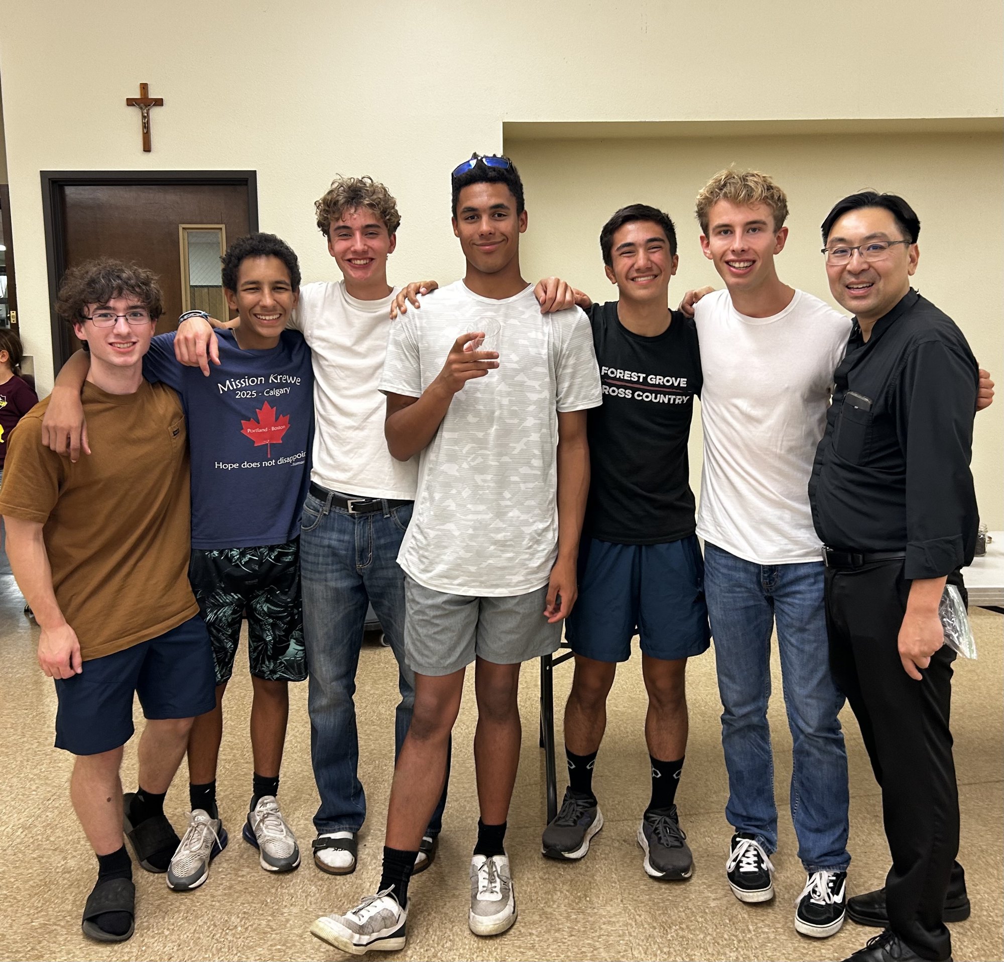 High School Youth Group members with Fr. Michael at a fellowship dinner, October 2026