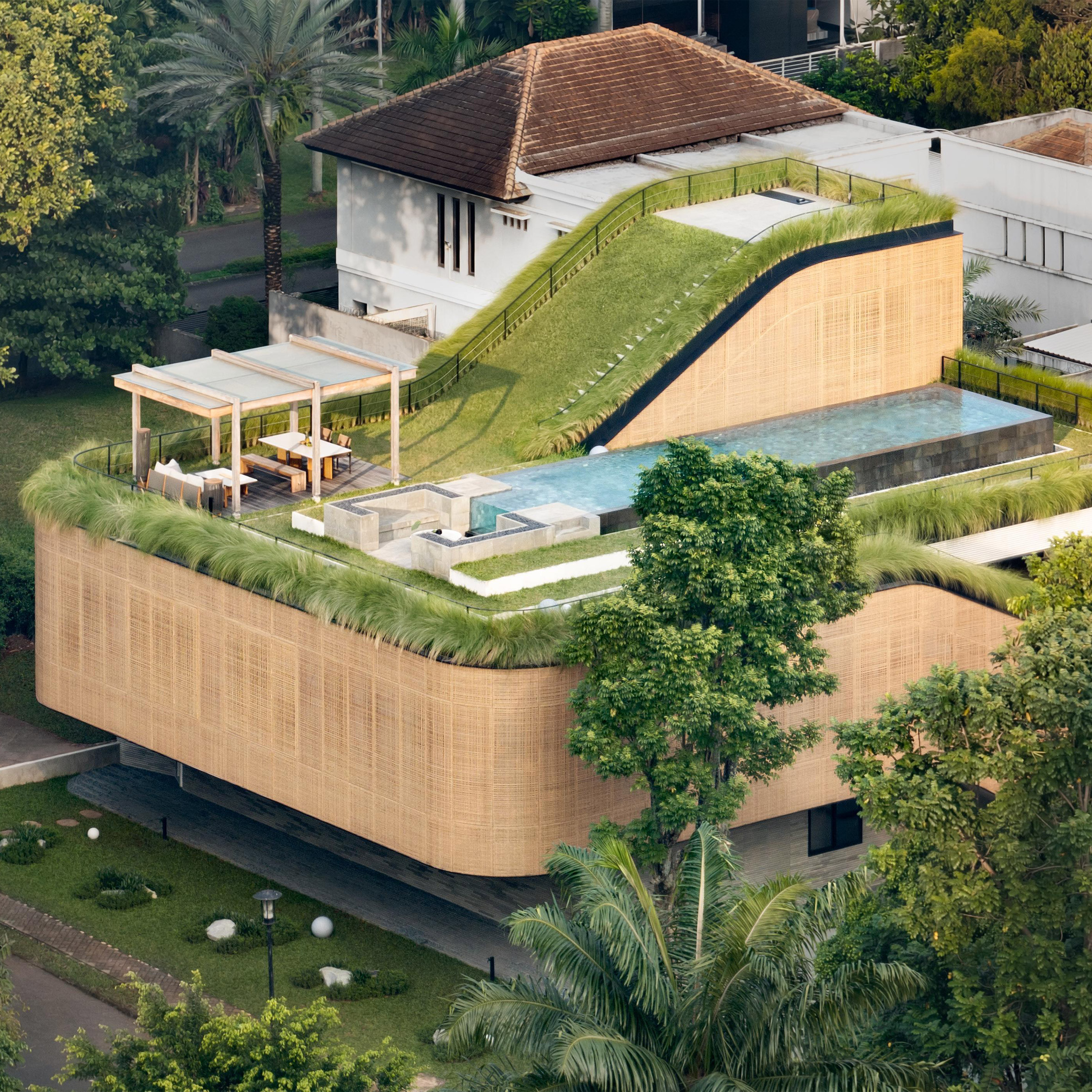 Sloping green roofs "keep the family connected" at Indonesian home