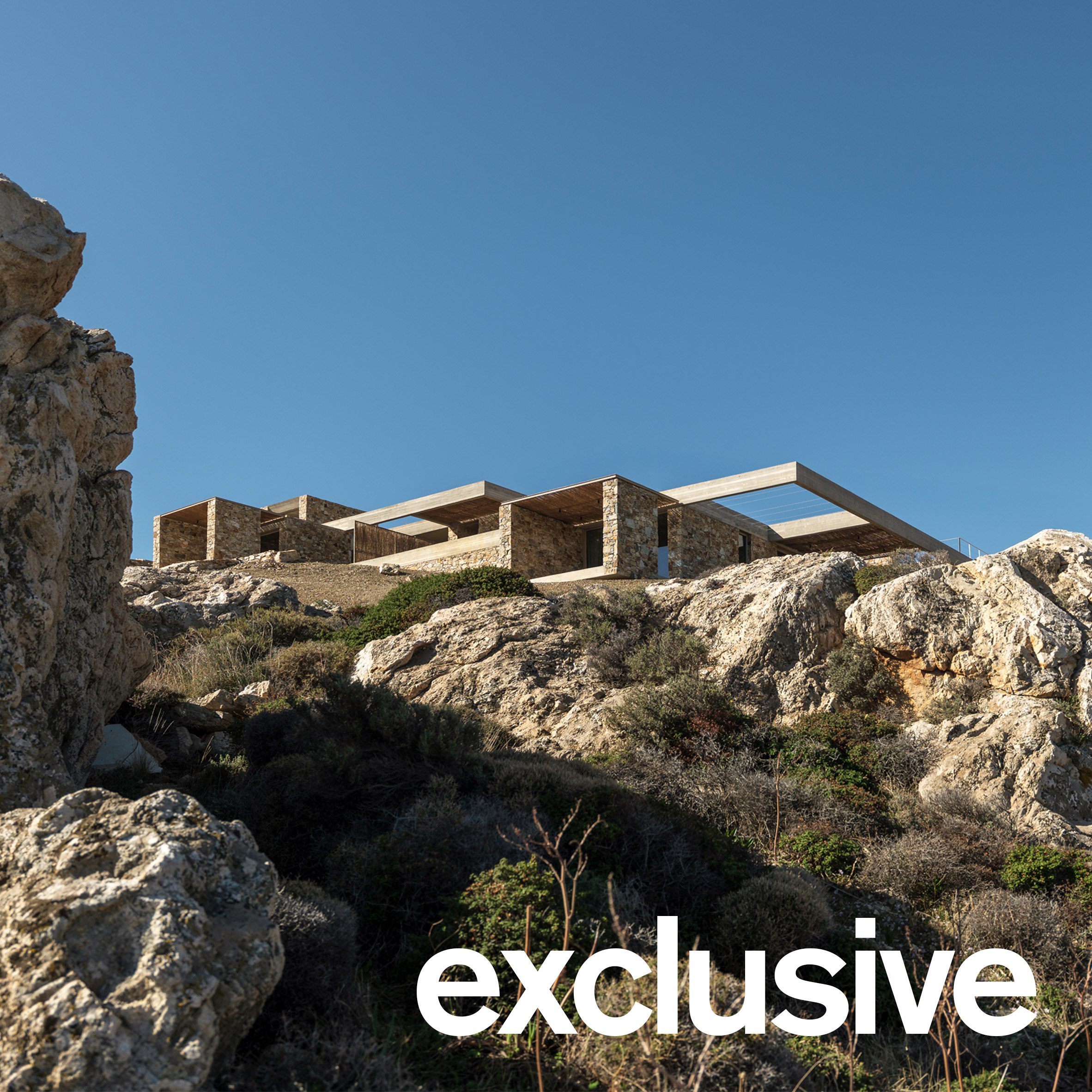 Stone-clad hospitality retreat embedded into a rocky hillside overlooking the Aegean Sea on Serifos