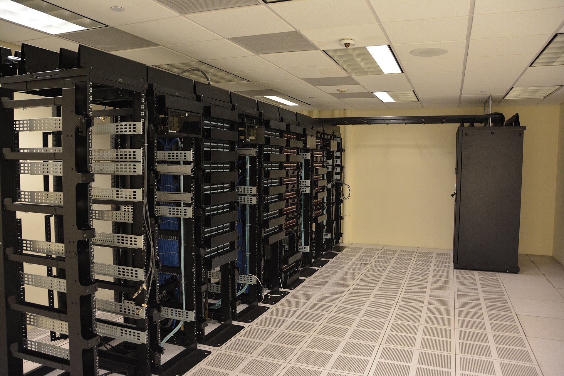 Rows of server racks in a data center, shown as an illustration of cloud computing.