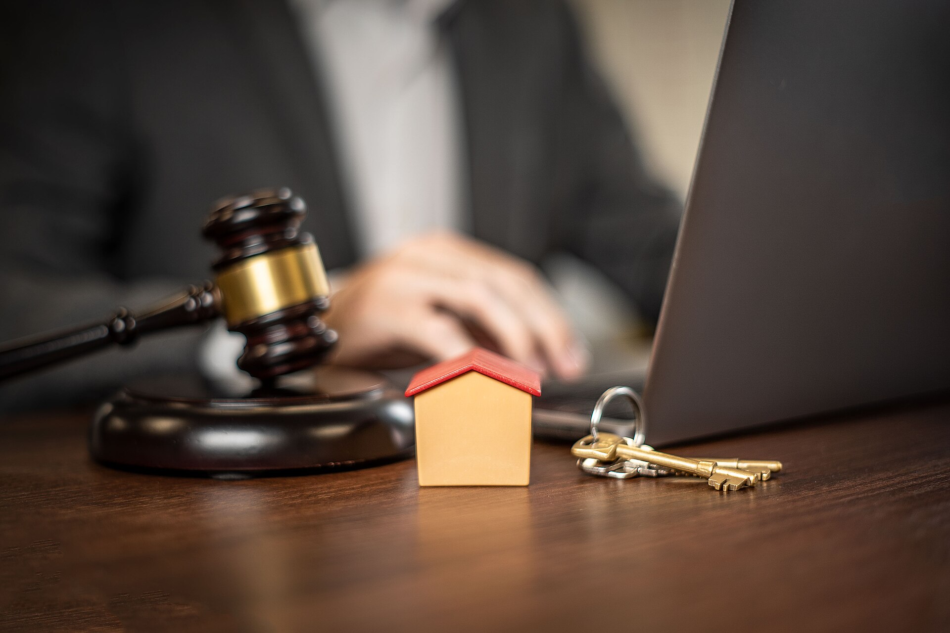 Property paperwork, a gavel and house keys illustrate mortgage lending.