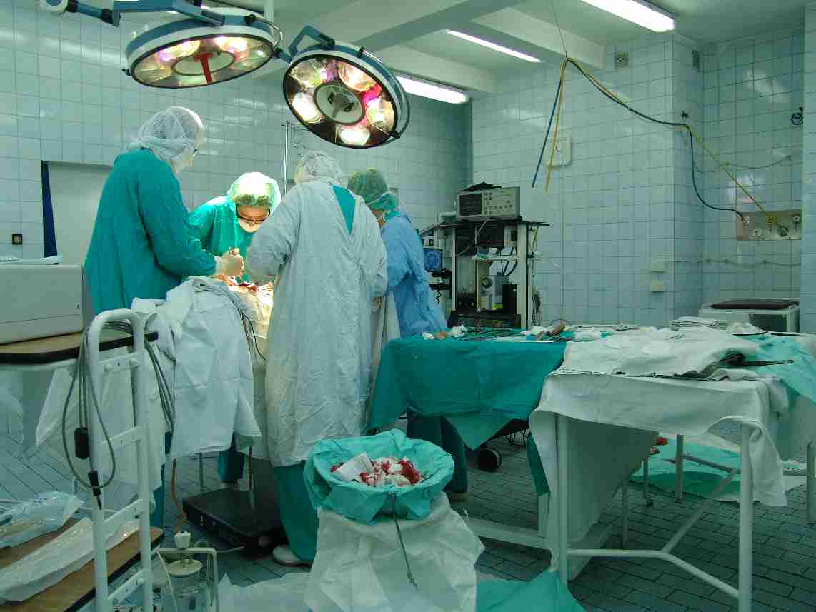 An operating theatre with surgical lights and medical equipment