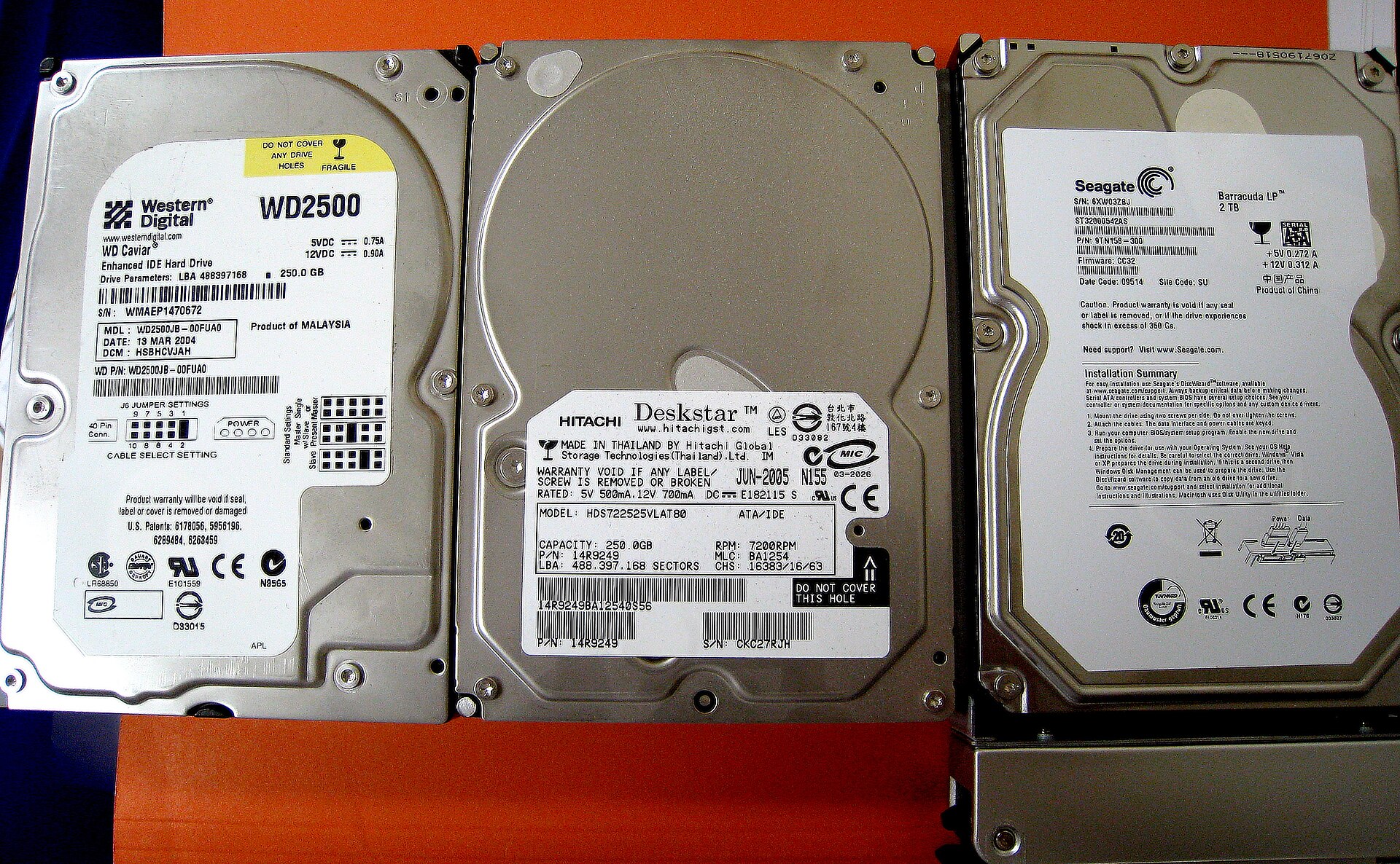 Three older hard disk drives from Western Digital, Hitachi and Seagate