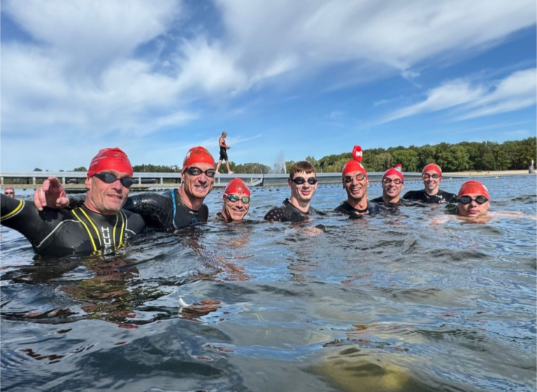 Group of athletes swimming together.