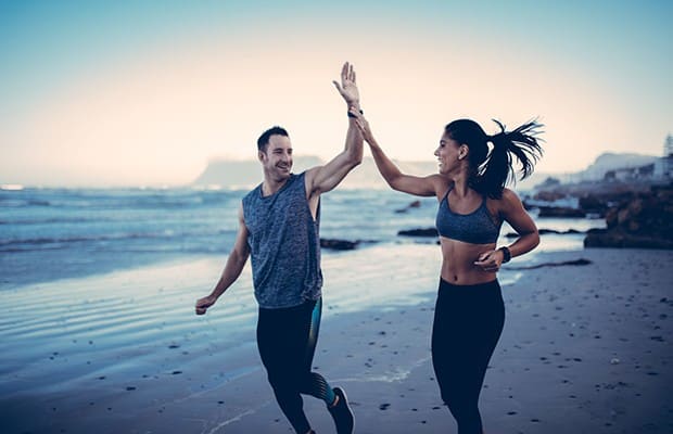 A person in a bright room performing a deep fascial stretch.
