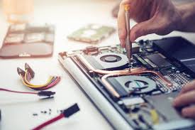Сервис за Компјутери и Лаптопи - A technician repairing a laptop.