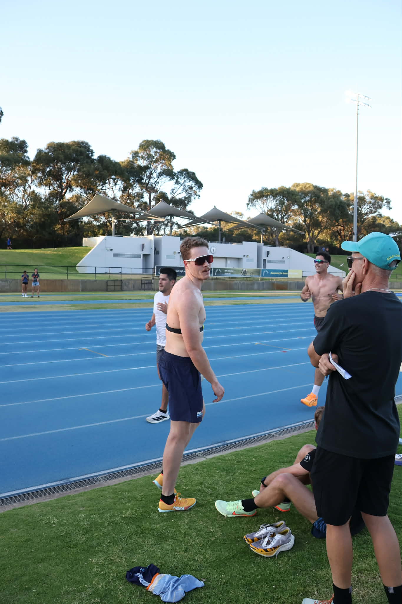 Conferring with Coach Stu at the track