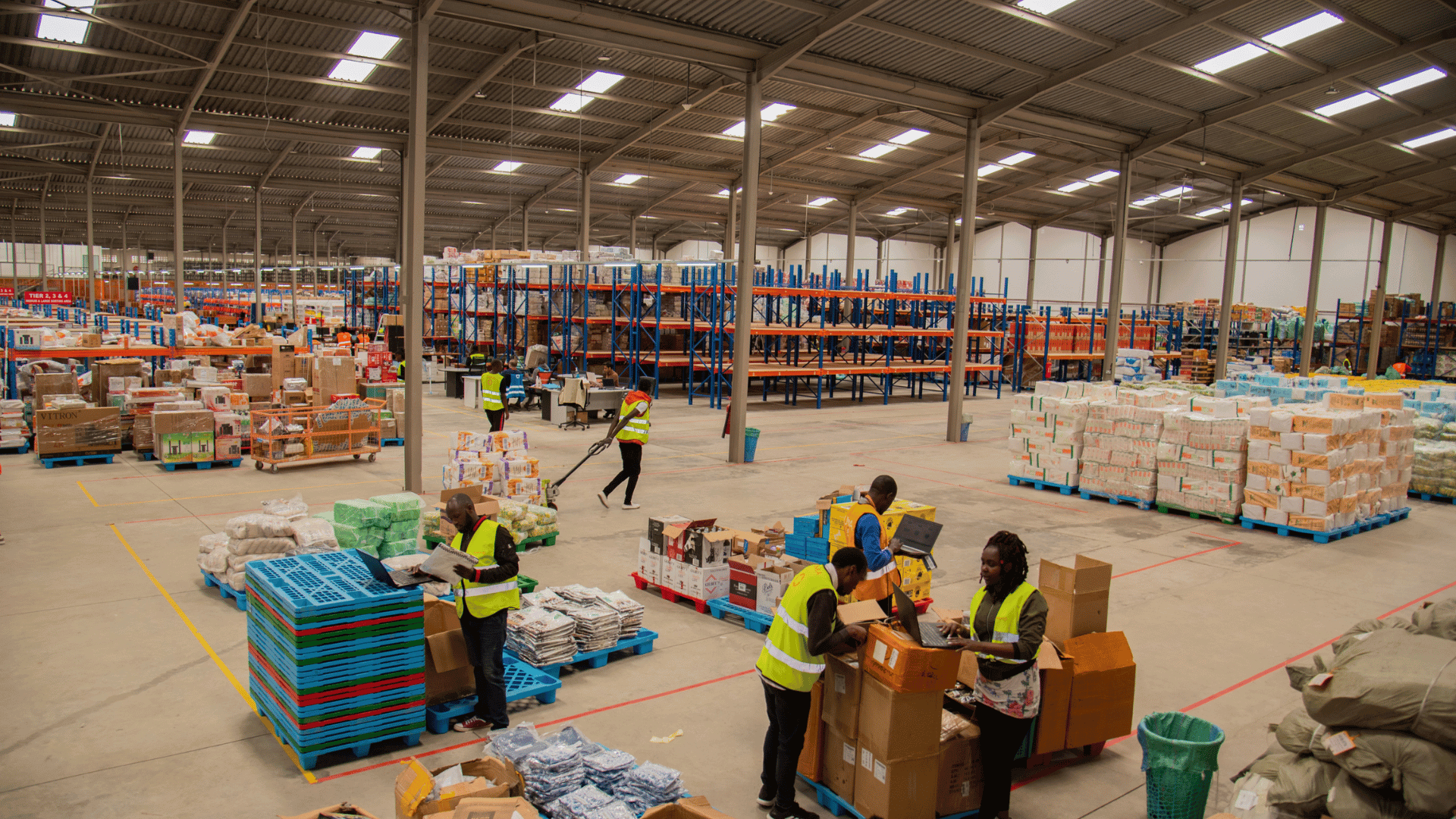 A modern warehouse with packages on shelves, illustrating logistics.