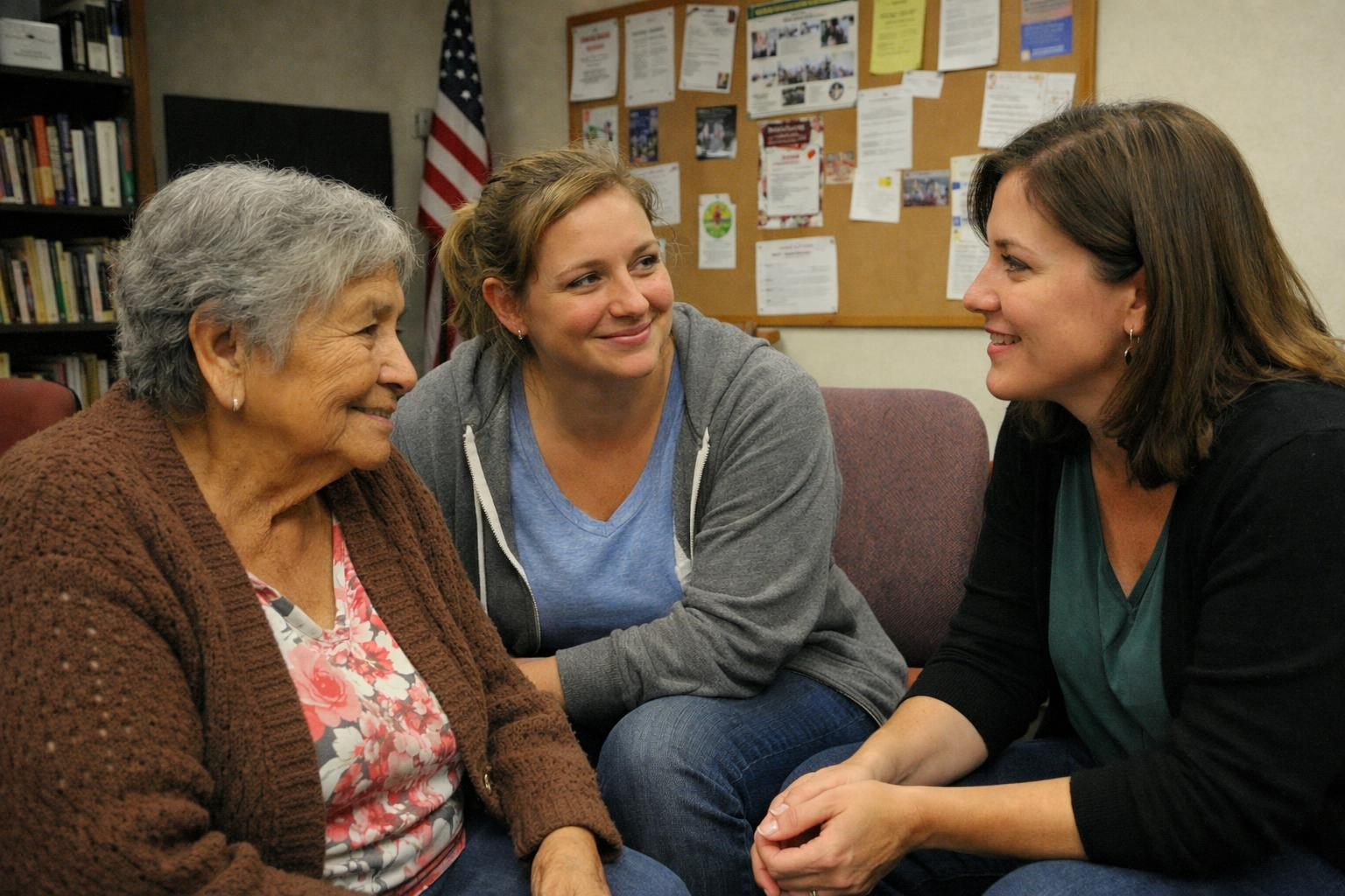 Older adults and a caregiver reviewing transportation information together