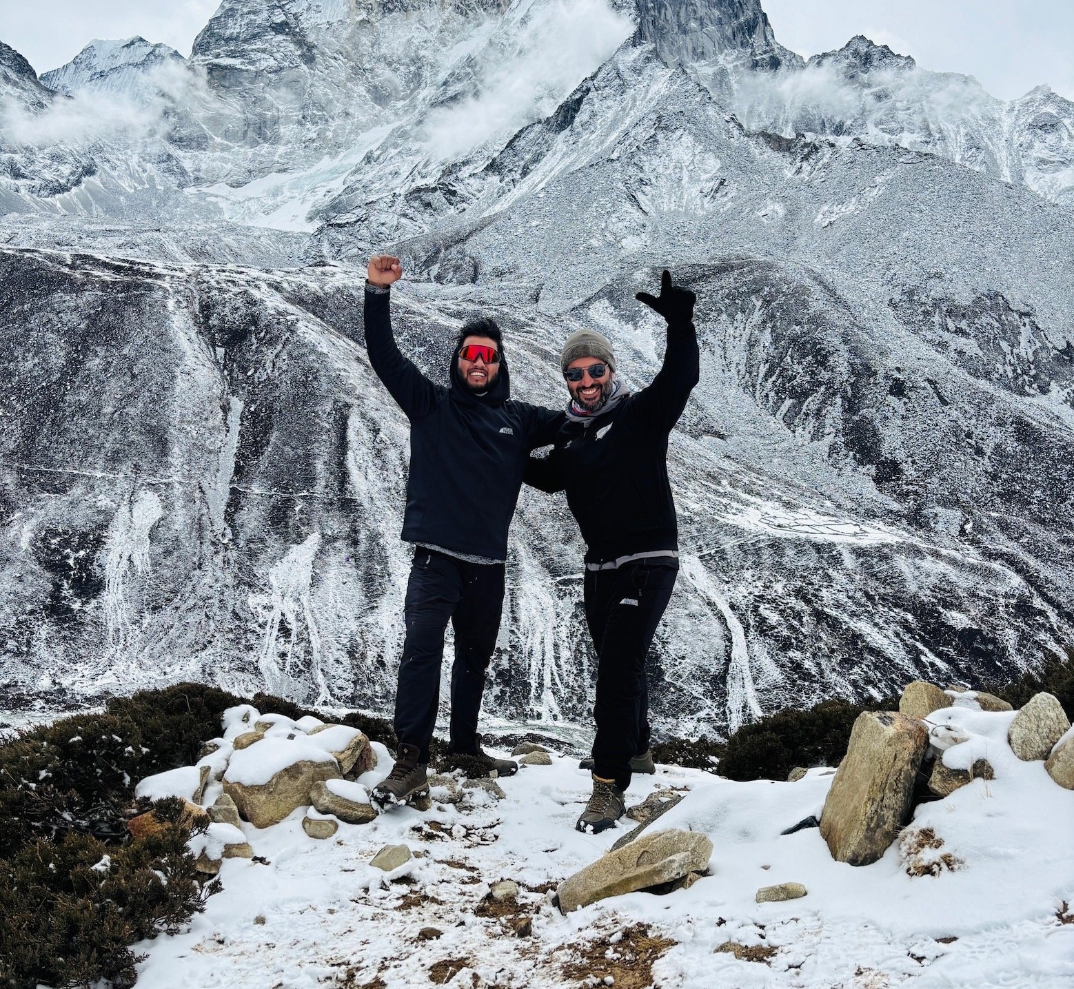 Trekker and guide posing at Everest Base Camp