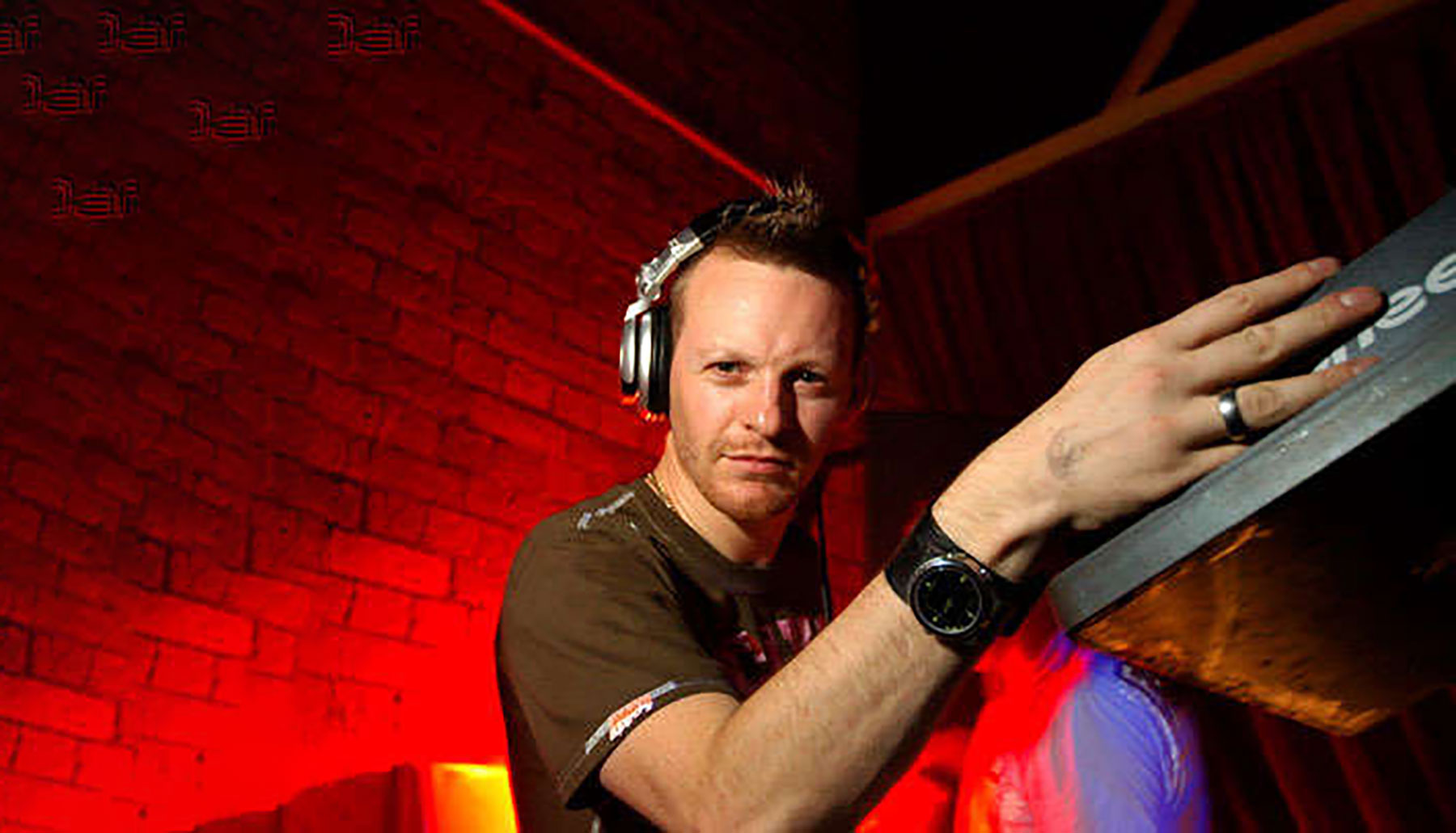 Stan Matthew DJing at a club with red lights