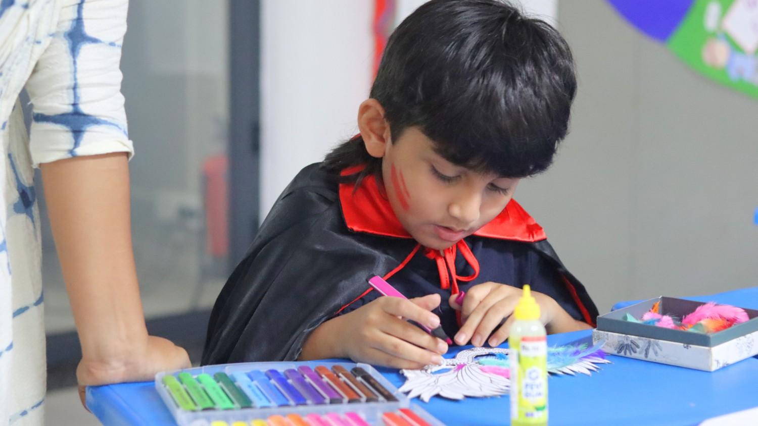 student painting canvas