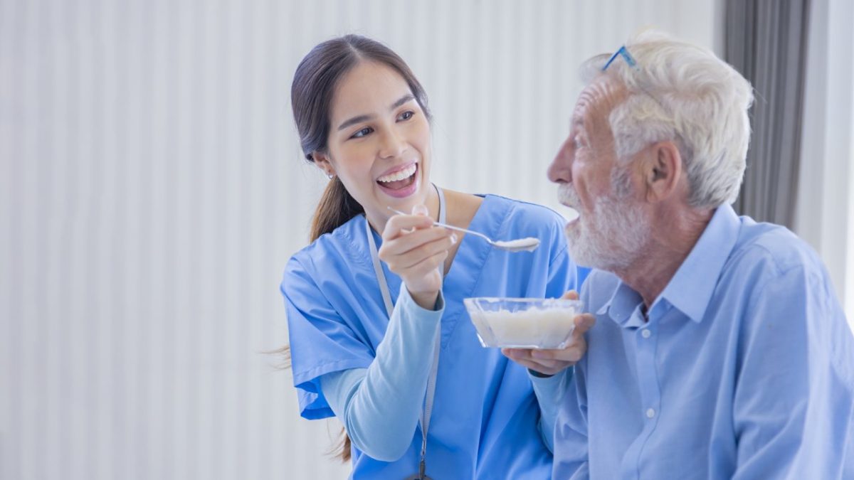 A caregiver assisting an elderly person at home.