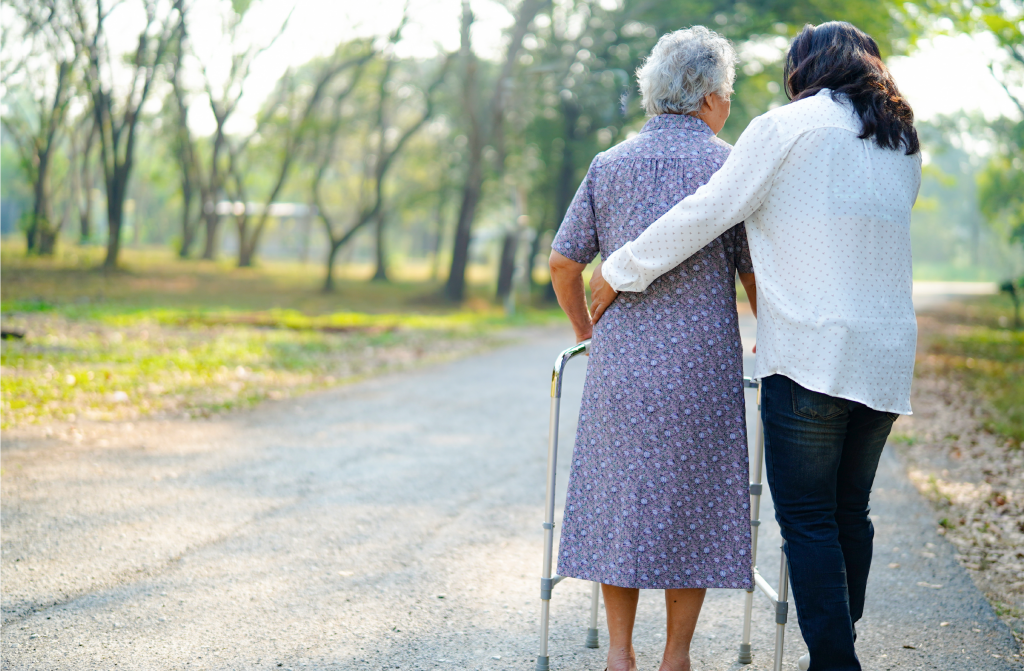 A friendly doctor talks with an elderly woman in a bright room.