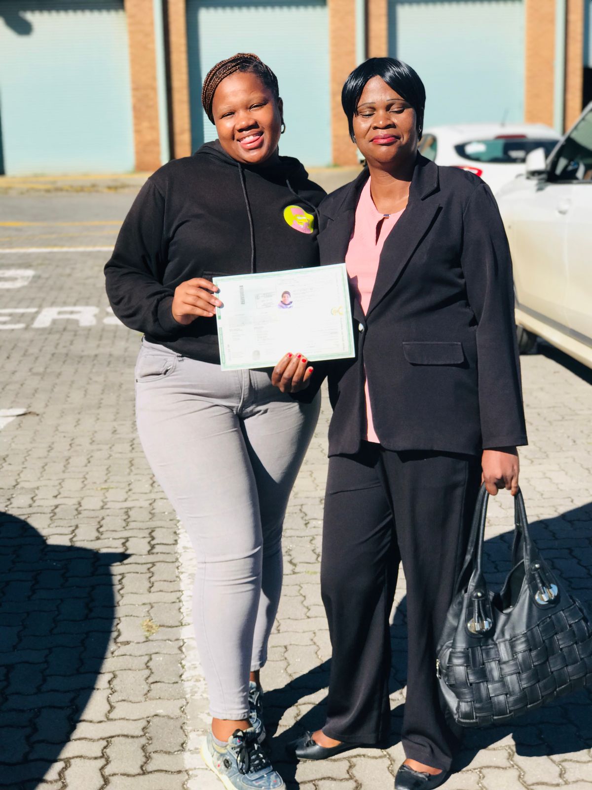 Another happy student holding their license.