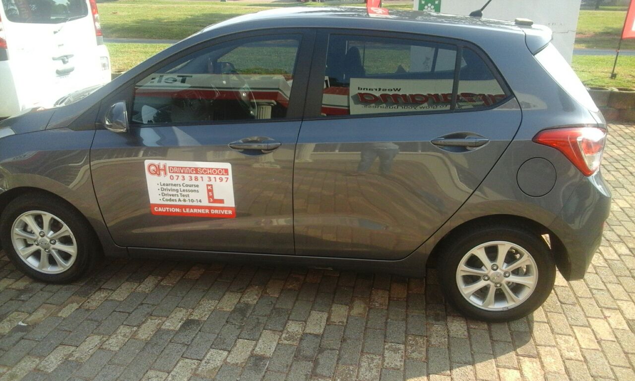 QH Driving School branded car.