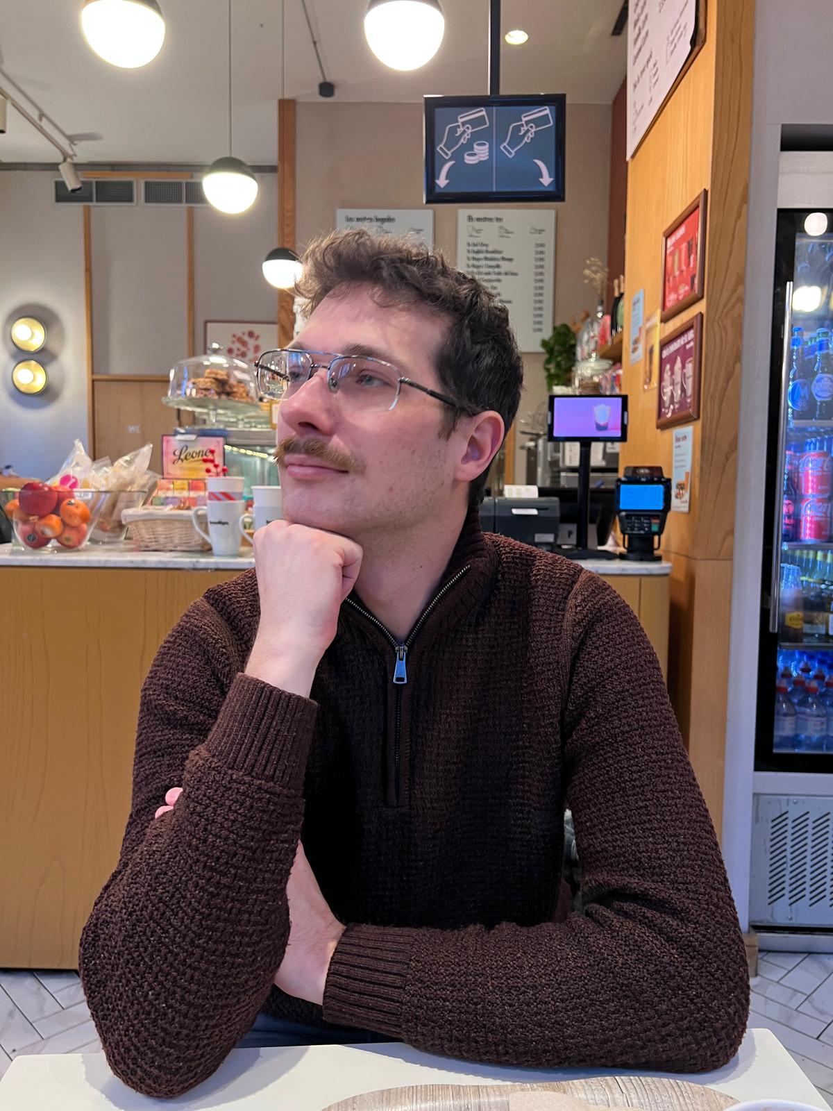 Mike Buesch at a desk, in thought