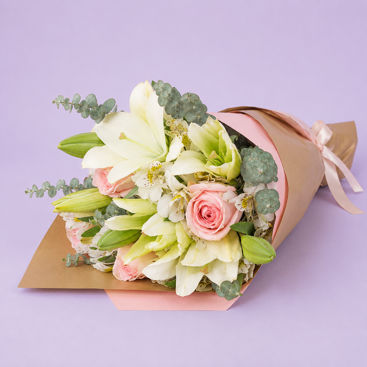 Bouquet of pink roses, alstroemeria, and white lilies.