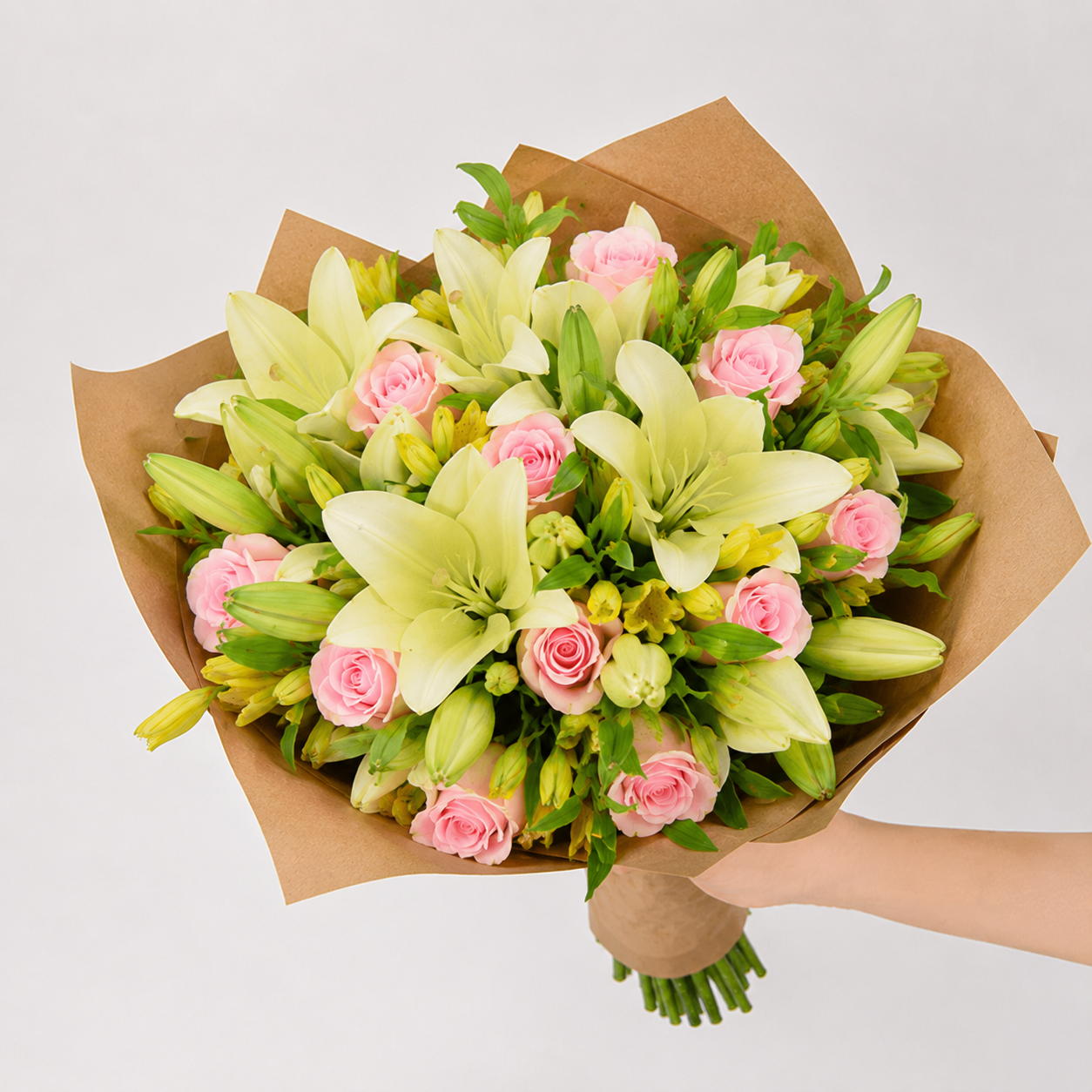 Bouquet of yellow lilies and alstroemerias with pink roses.