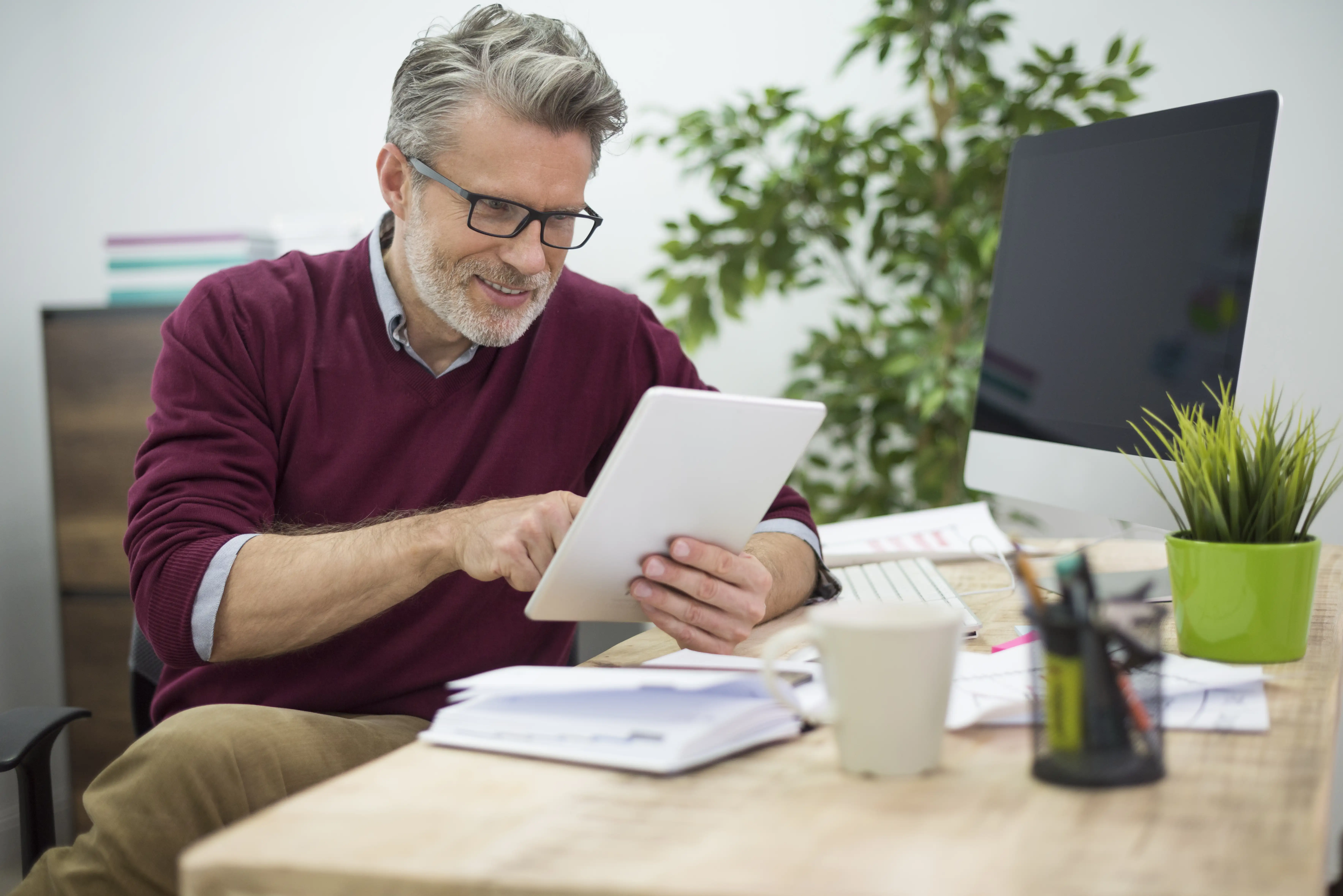 Relaxed business owner looking at a tablet