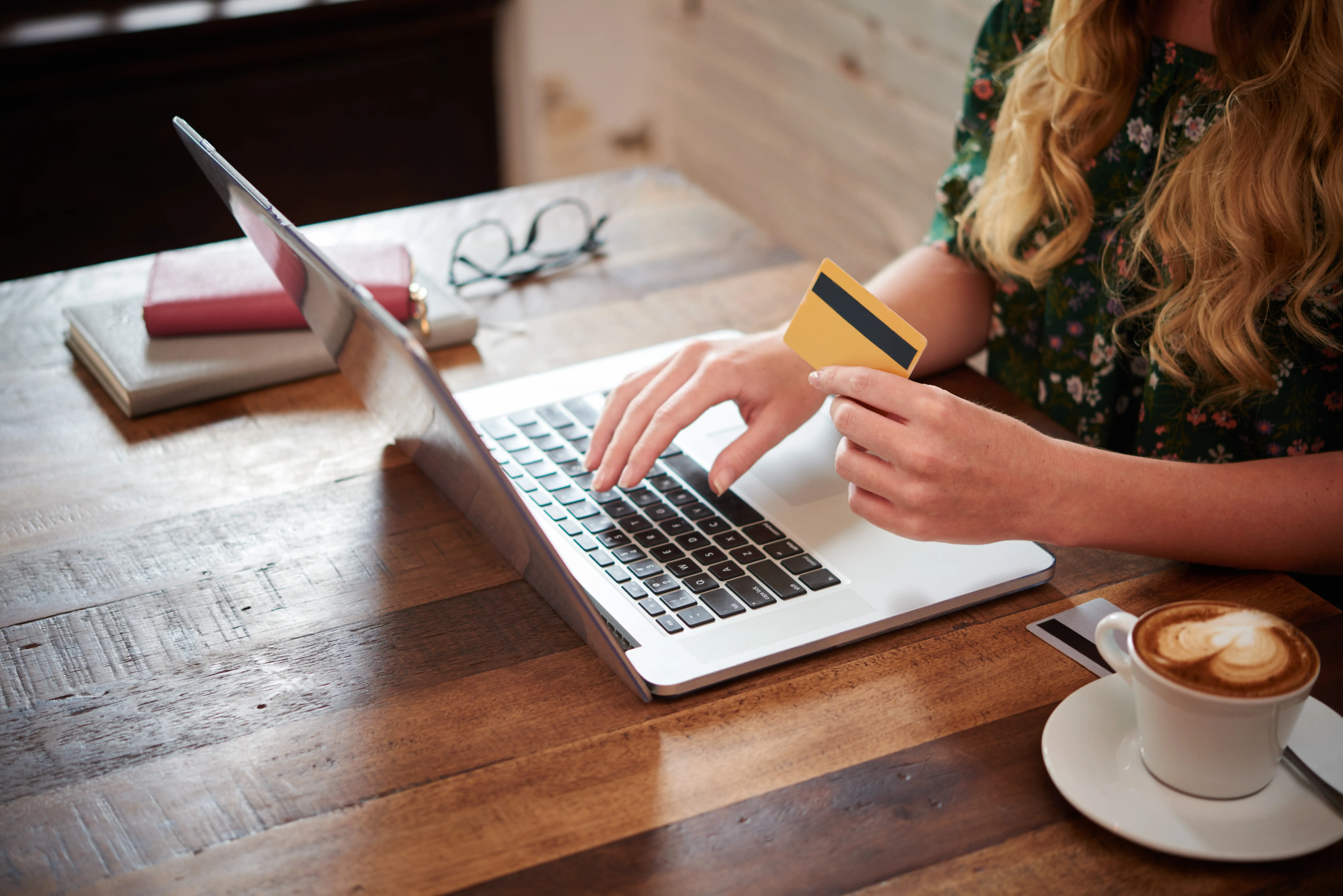 Person paying with a credit card on a laptop