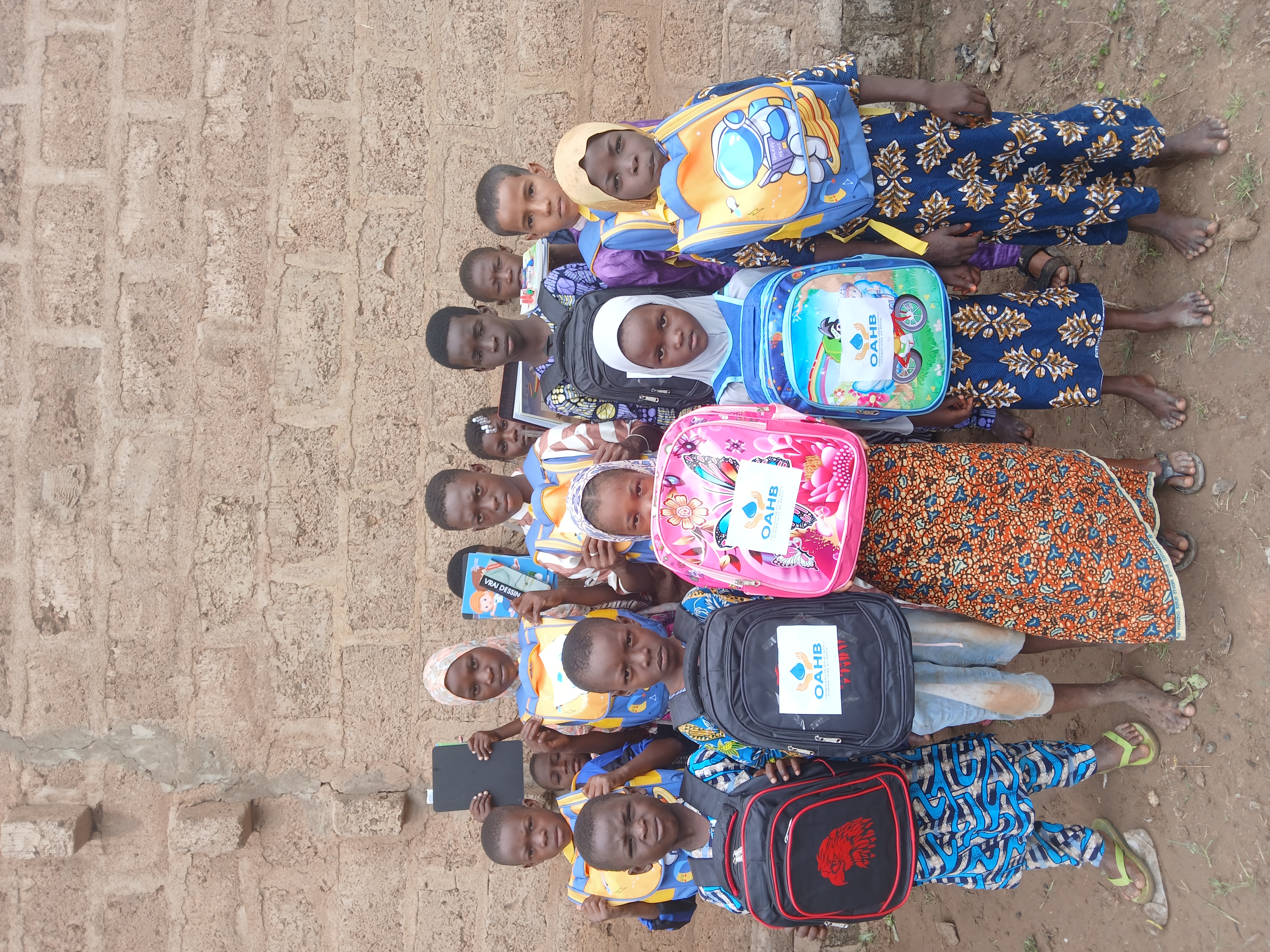 Children in a classroom with new school supplies.