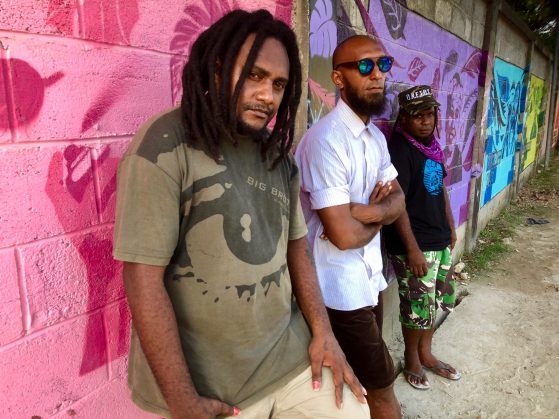 A band playing on a stage at a festival.