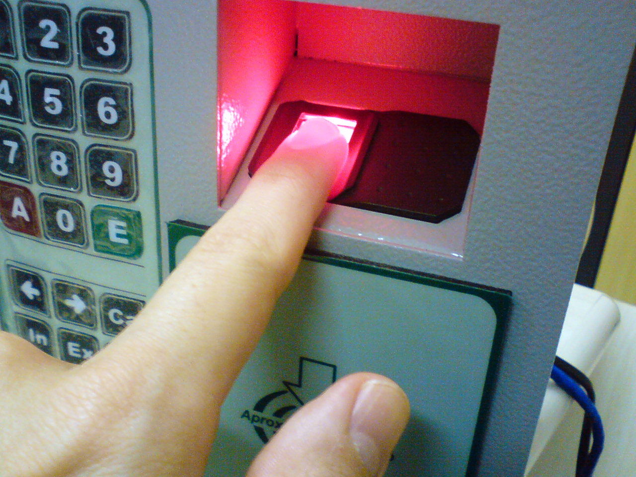 A person using a fingerprint scanner for secure building access.