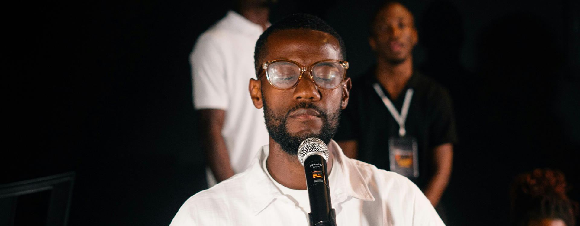 A congregation worshiping with hands raised.