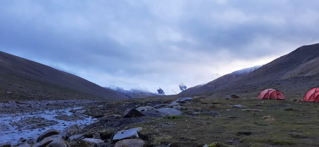 Panoramic view from the summit of Dzo Jongo, showing the vast Himalayan landscape.