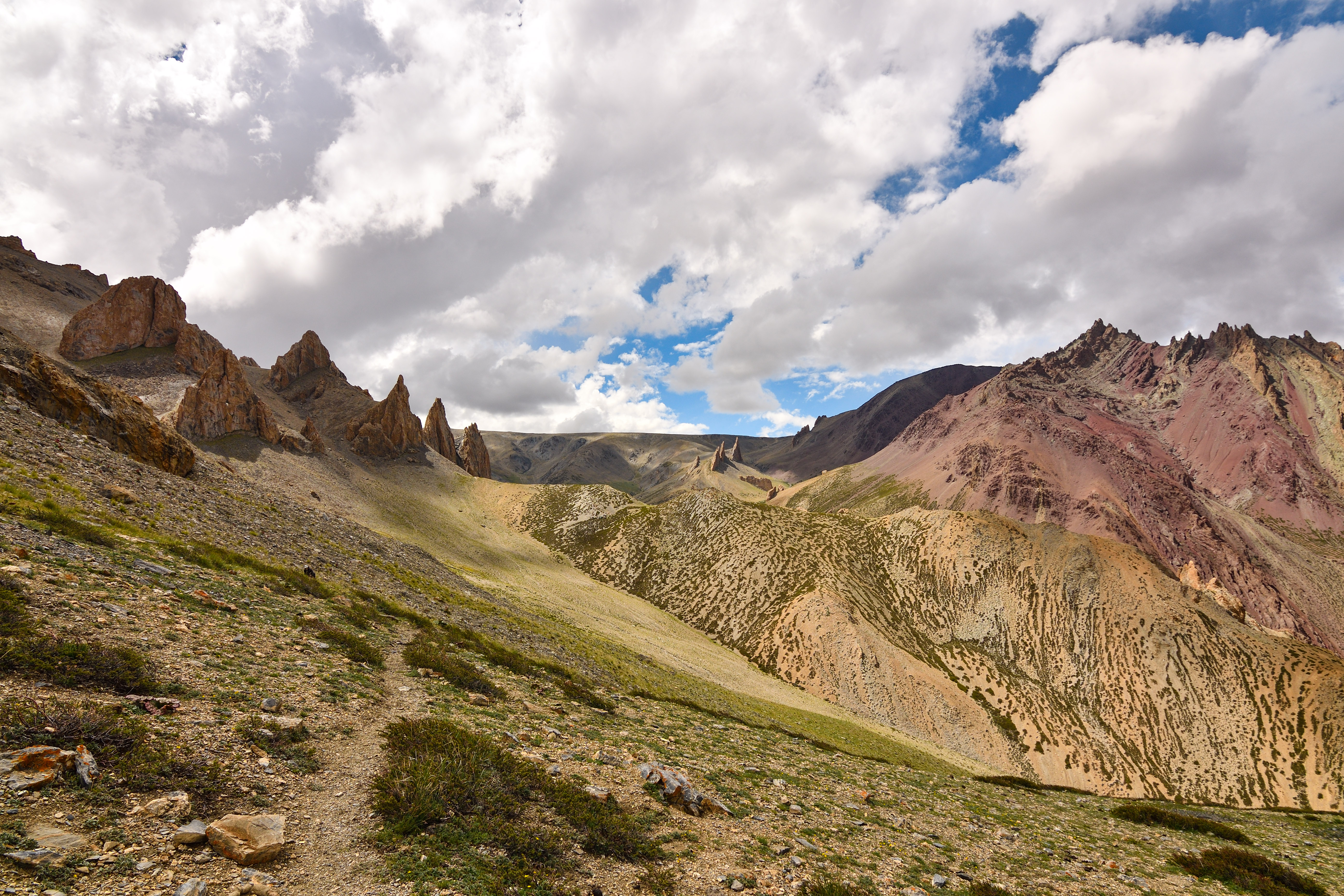 A wide shot of the Dzo Jongo mountain range under a clear blue sky.