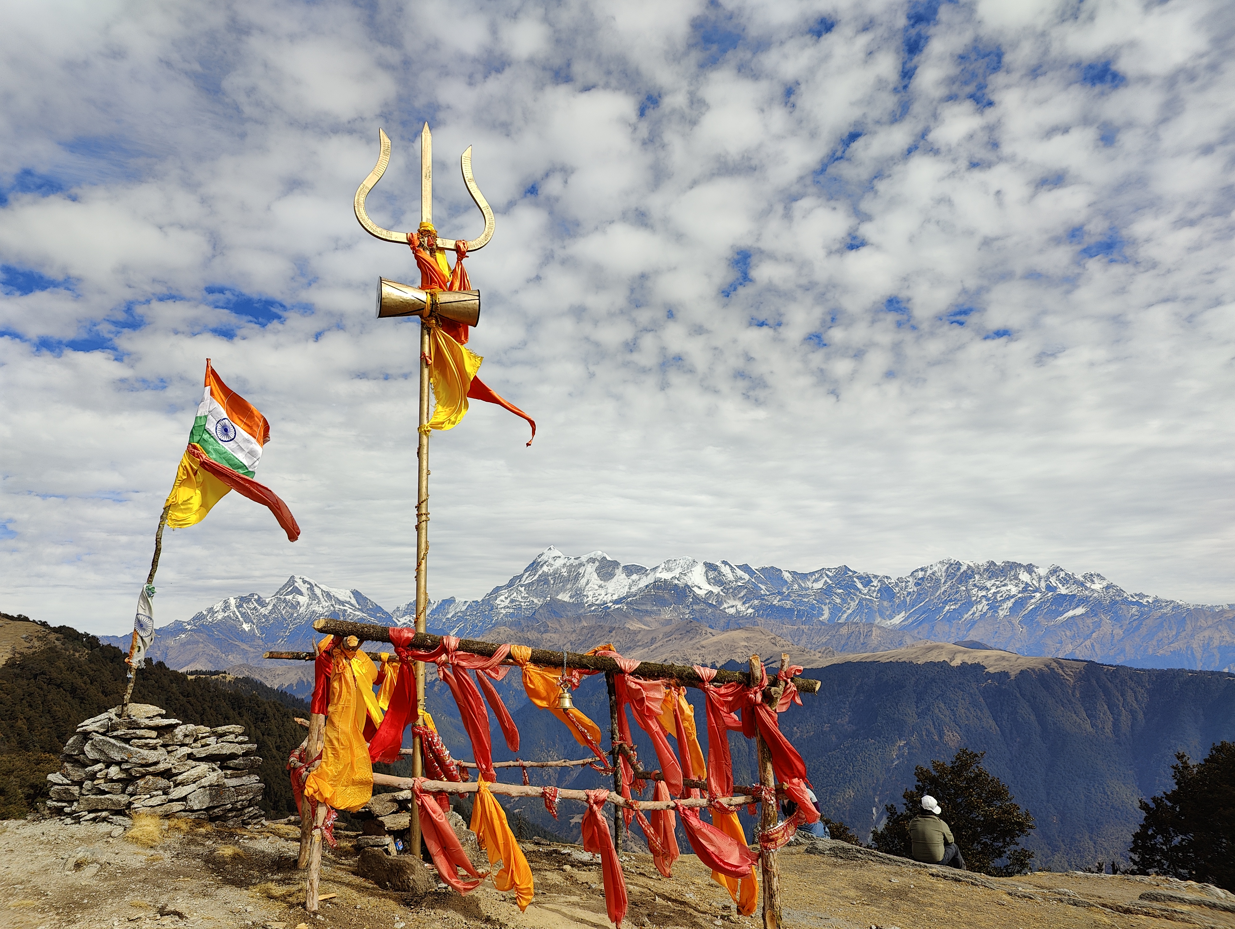 Climbers making their way up a snow-covered ridge towards the brahmatal summit.