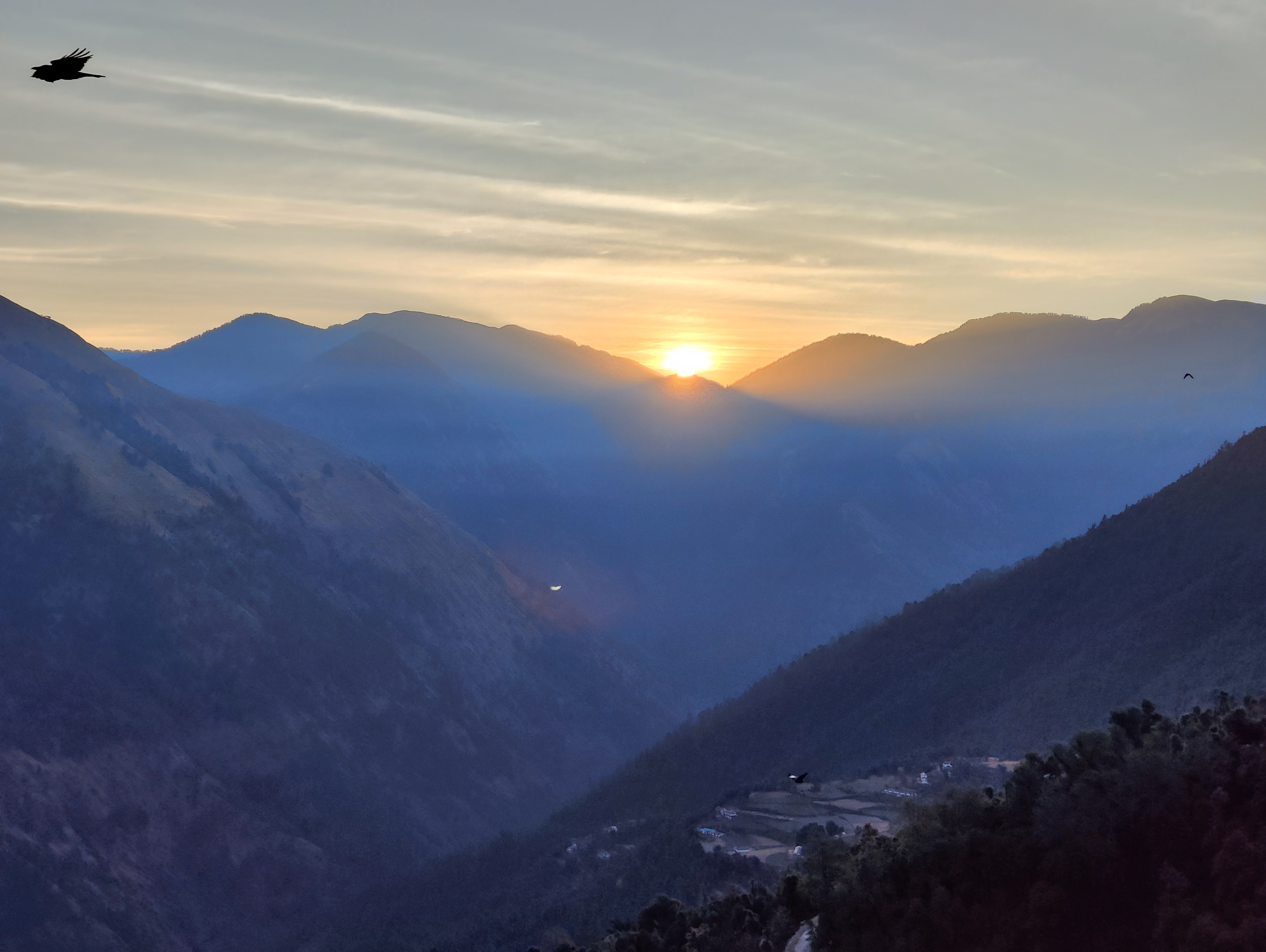 A tent at the brahmatal base camp with prayer flags and the peak in the background.