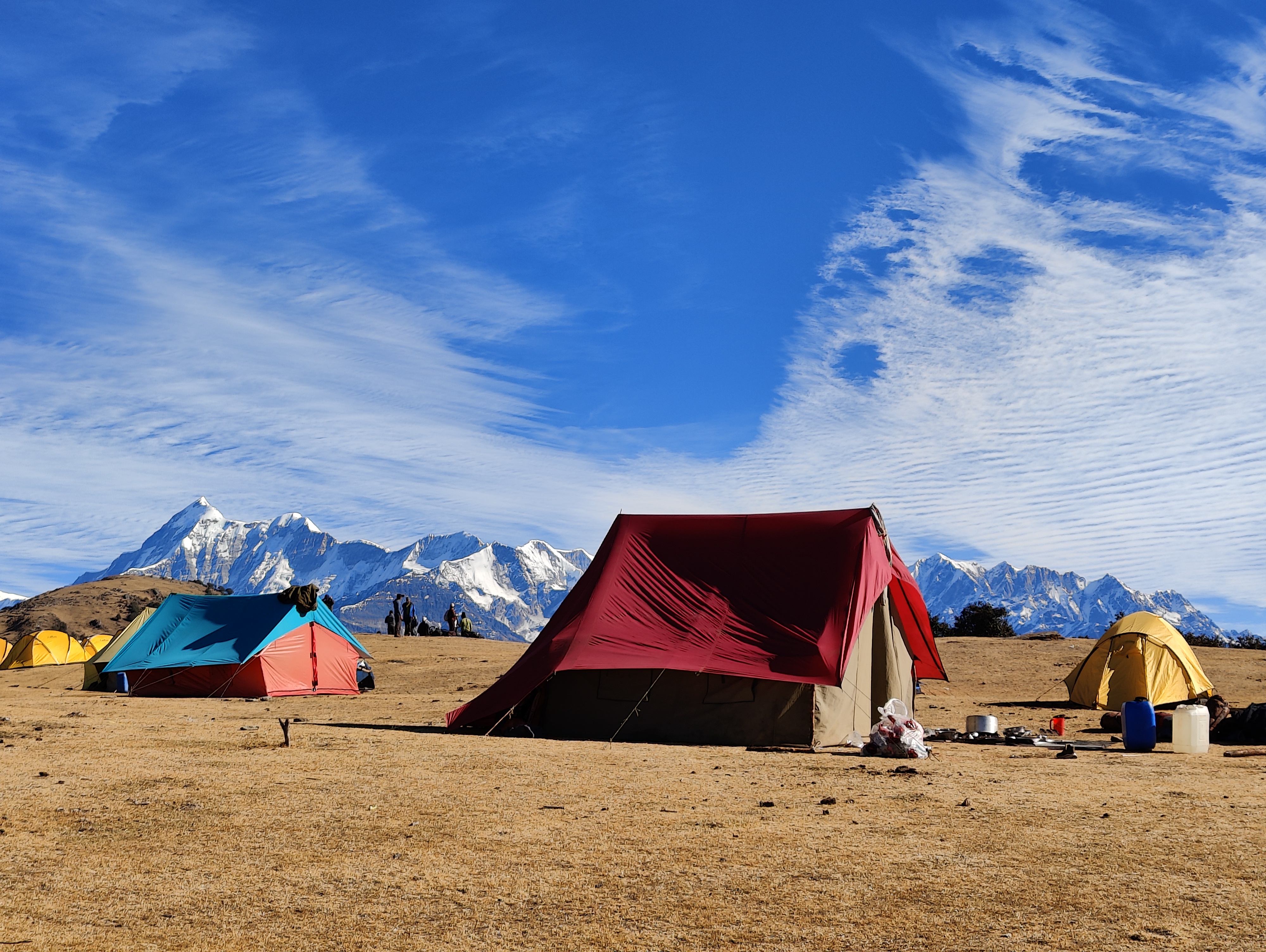 Panoramic view from the summit of brahmatal, showing the vast Himalayan landscape.