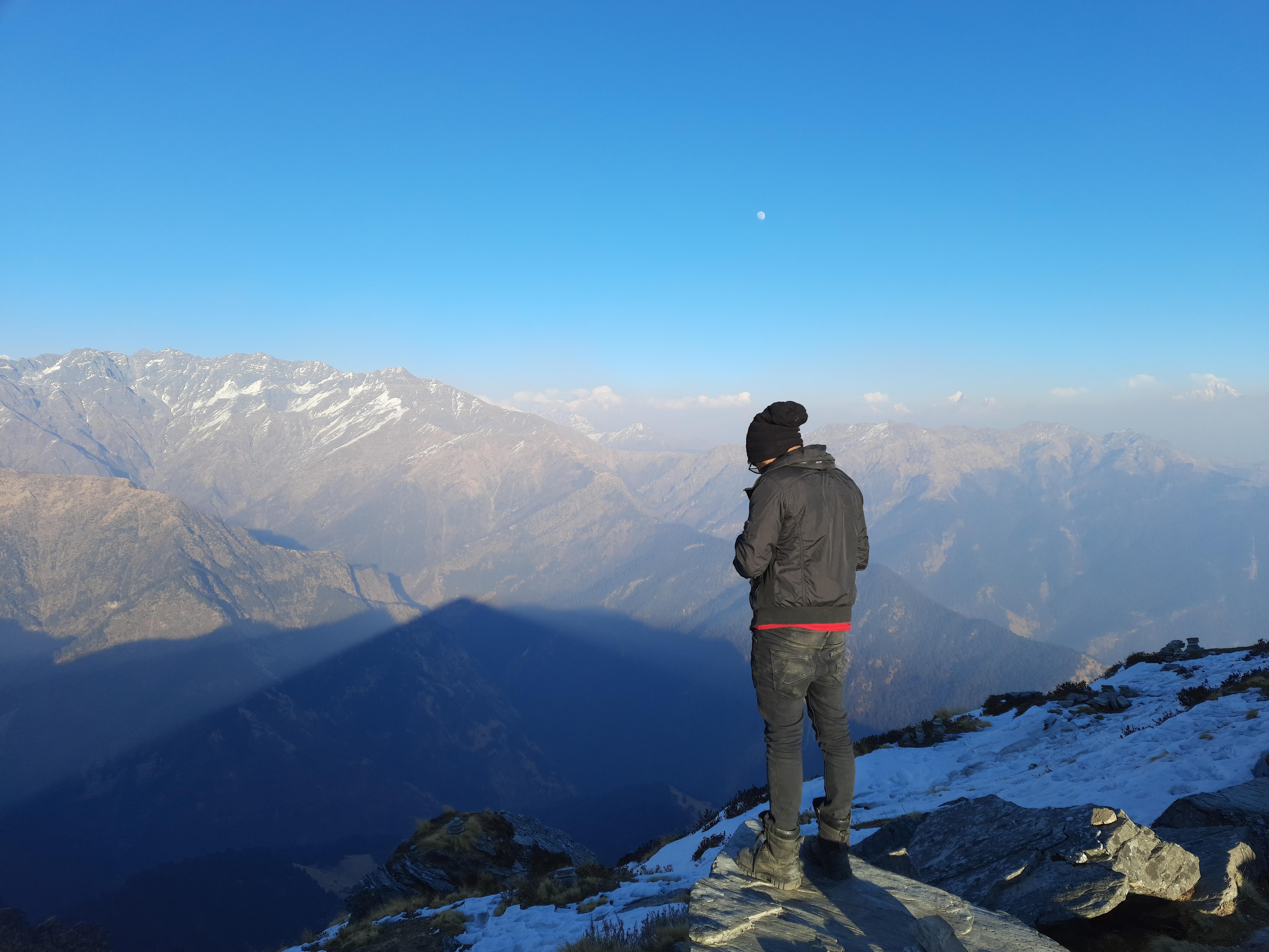 A wide shot of the brahmatal mountain range under a clear blue sky.