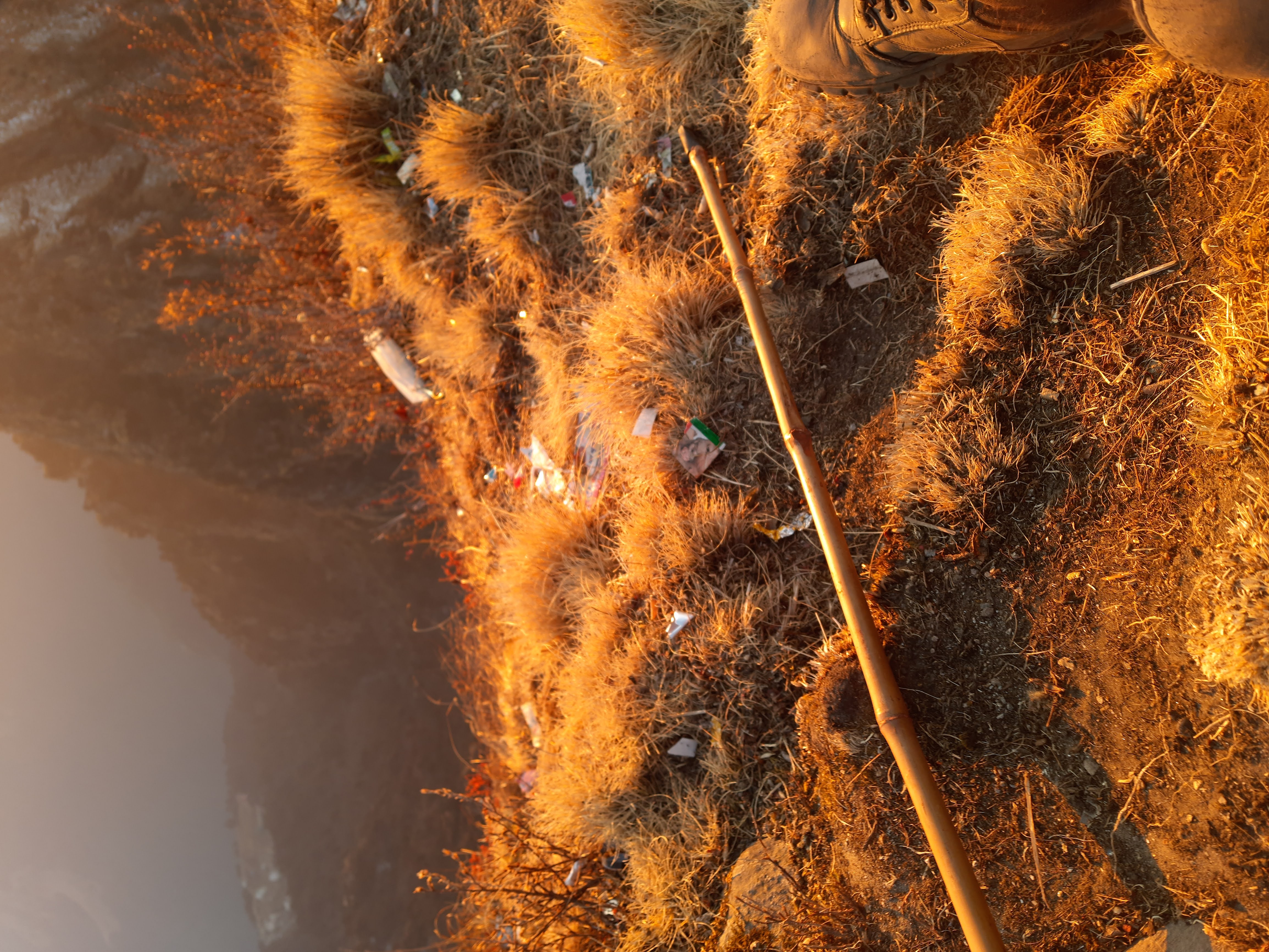 A tent at the chandrashila peak base camp with prayer flags and the peak in the background.