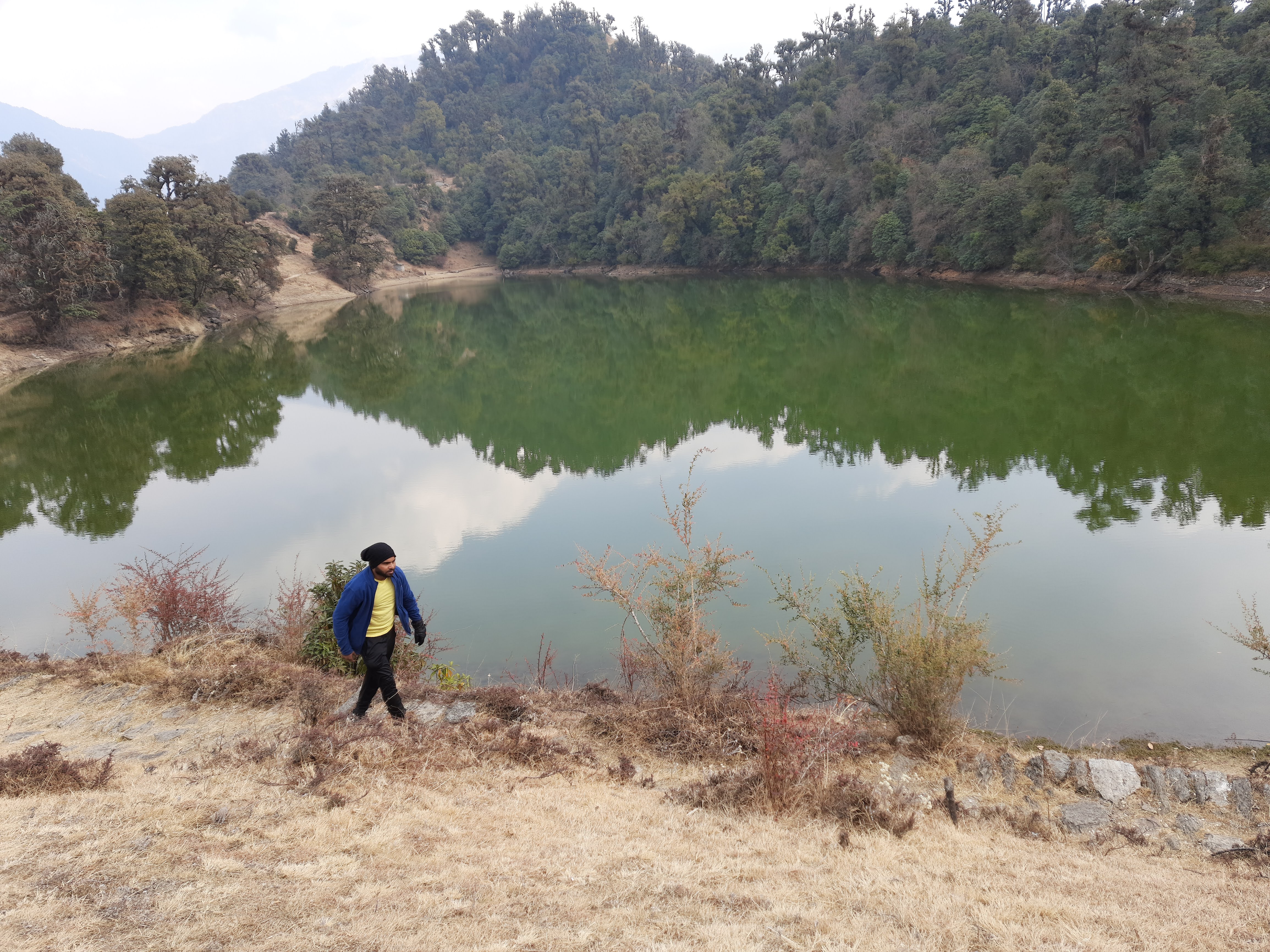 A tent at the deorital peak base camp with prayer flags and the peak in the background.