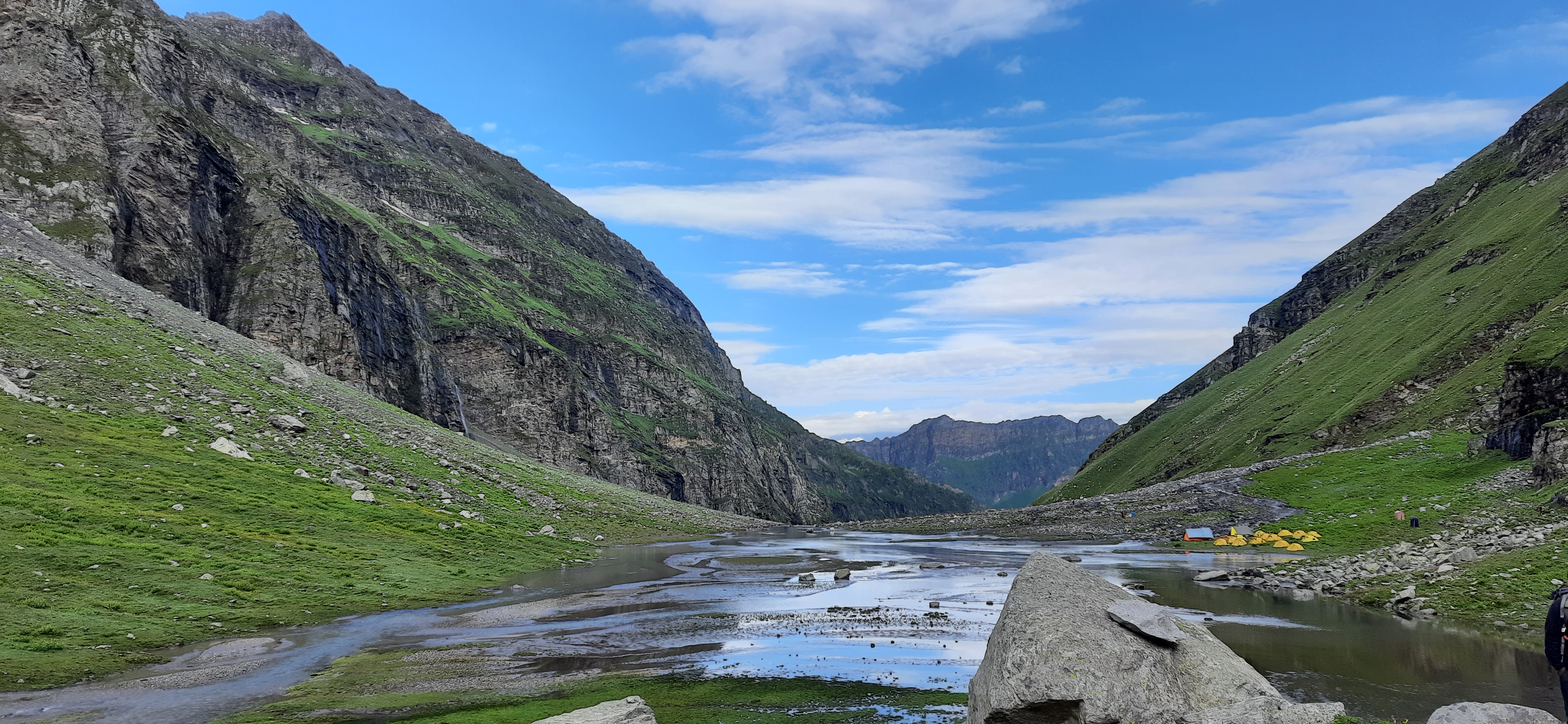 Panoramic view from the summit of hampta pass, showing the vast Himalayan landscape.