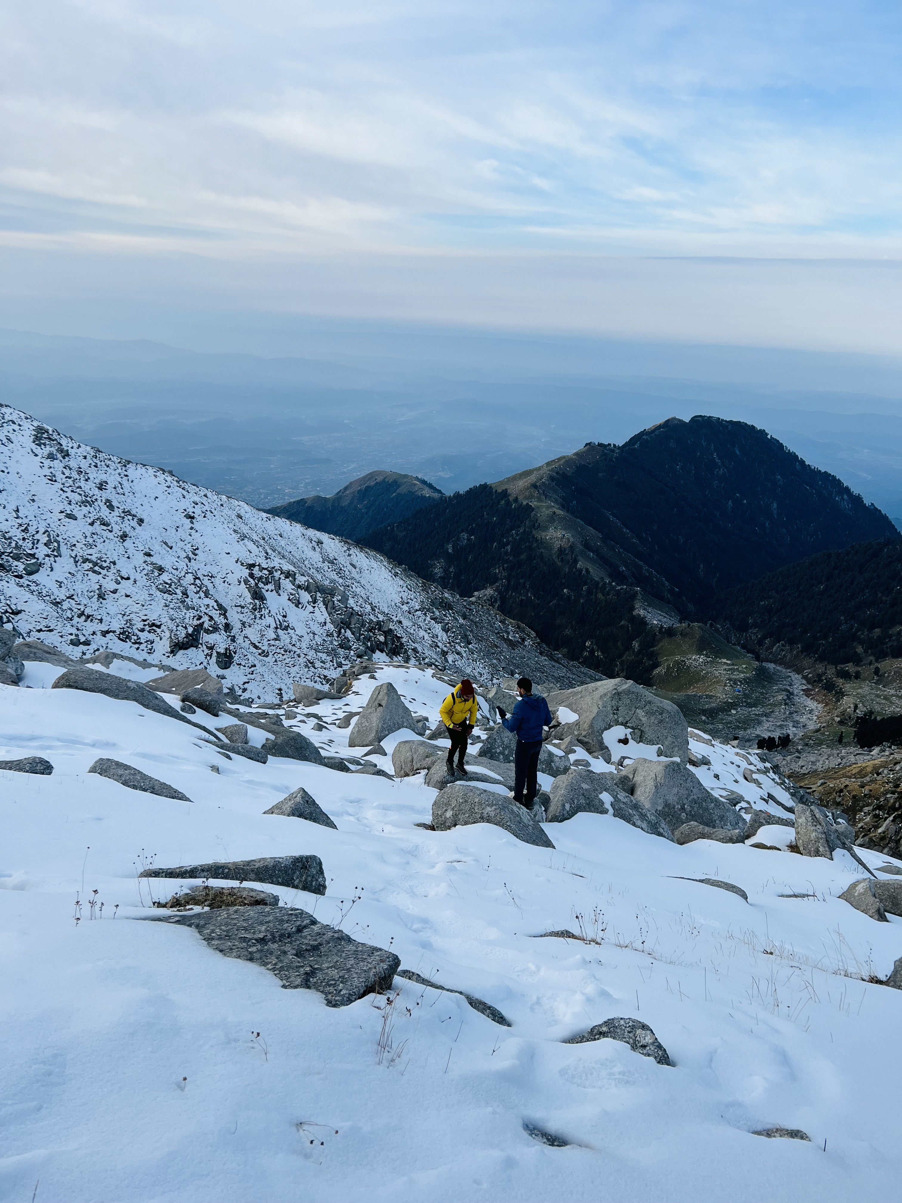 Panoramic view from the summit of indrahar pass, showing the vast Himalayan landscape.