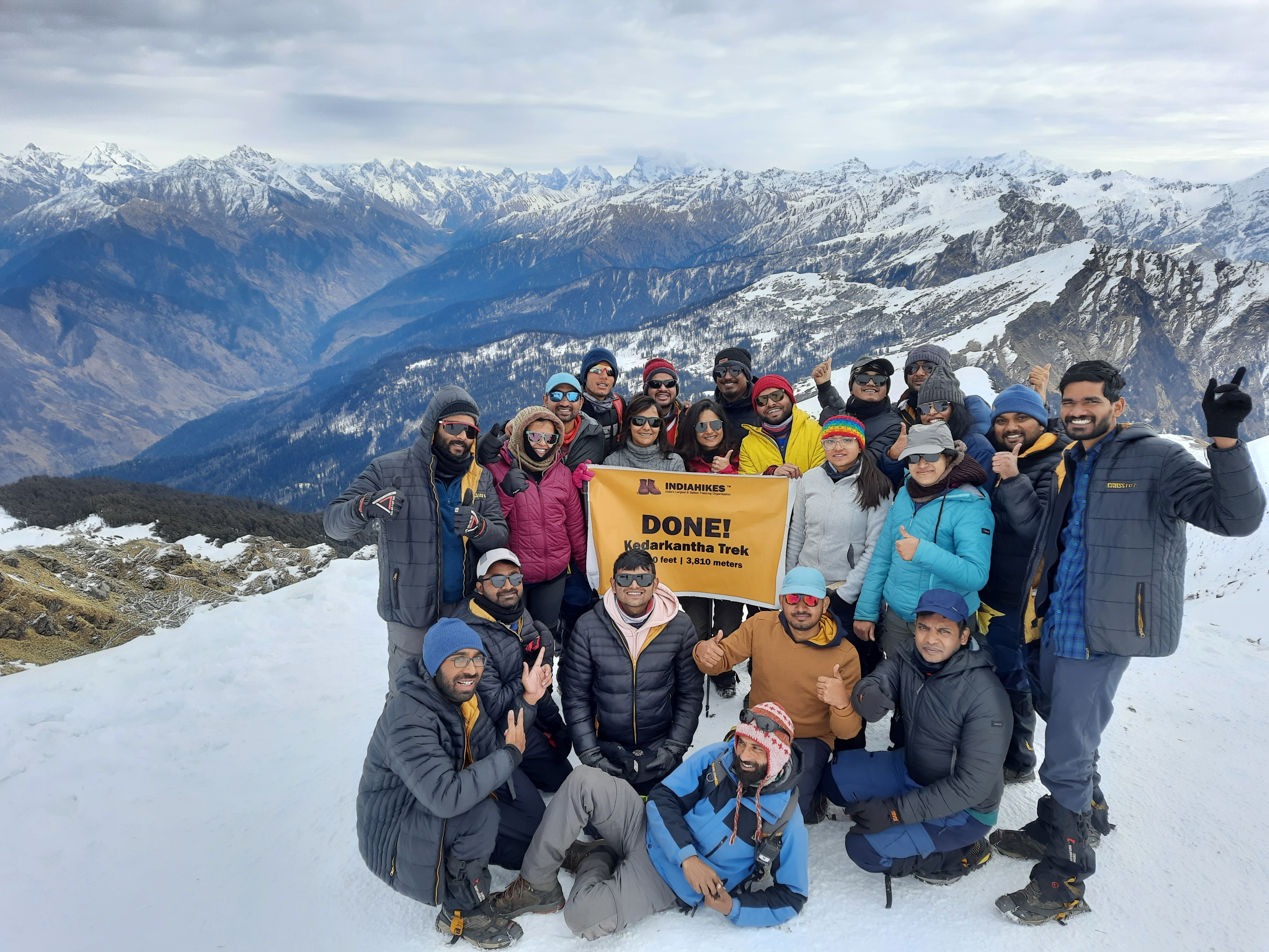 A wide shot of the Kedarkantha mountain range under a clear blue sky.